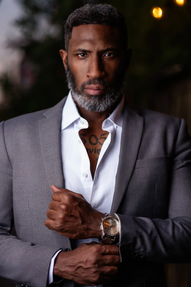 Professional portrait of a man in a grey suit