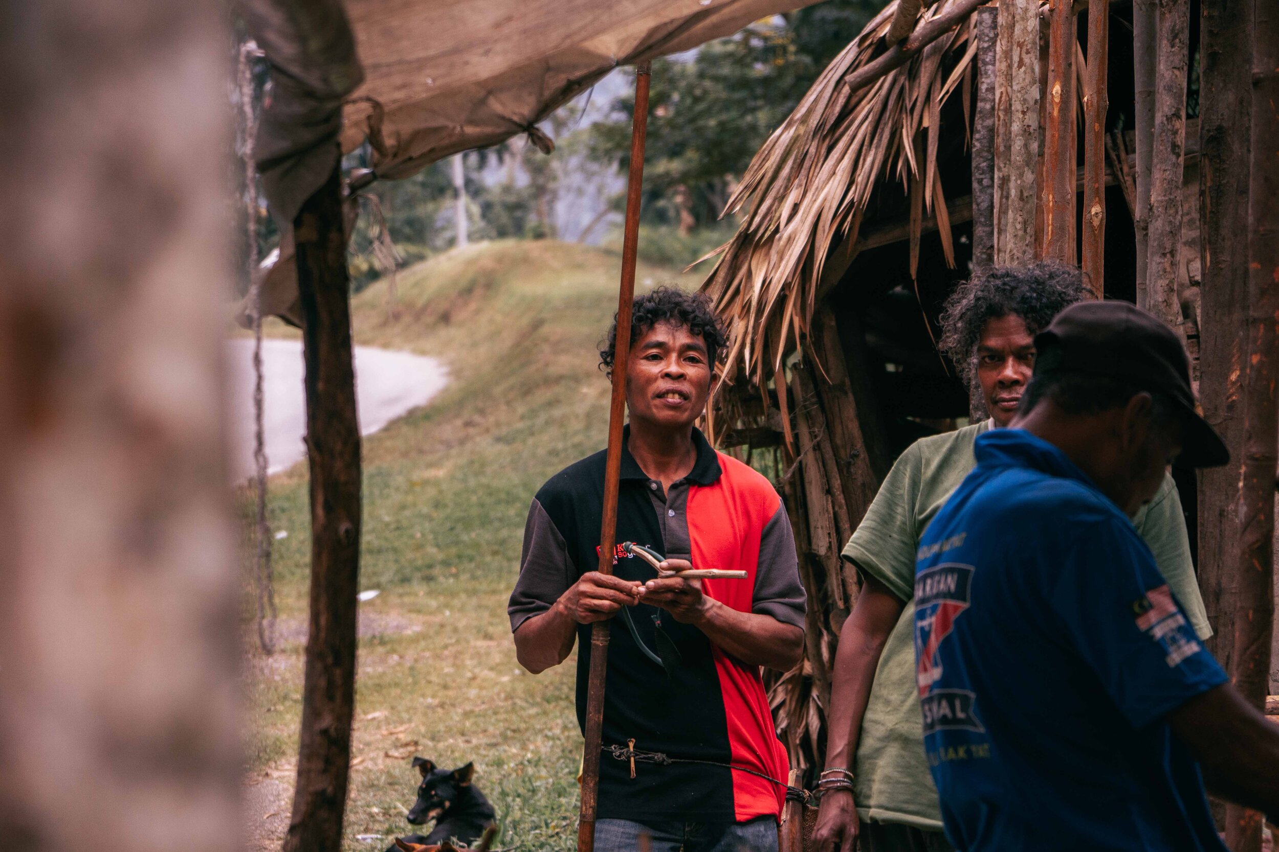  Our guide then introduced us to the rest of the Orang Asli living in this small village. One of them showed us his blowpipe — used to kill wild boars, and injure trespassers.  Yes, that long stick he’s holding is a  weapon .    