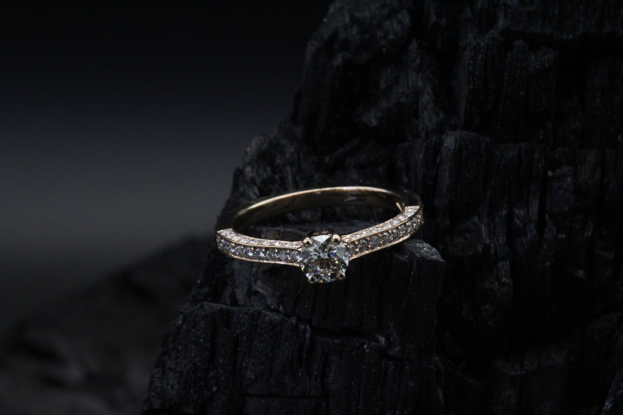 Diamond ring round cut set on a paved rose gold ring  