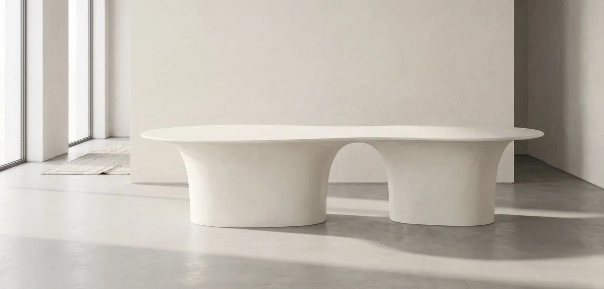 Minimalist white bench or table with curved base in a modern interior space