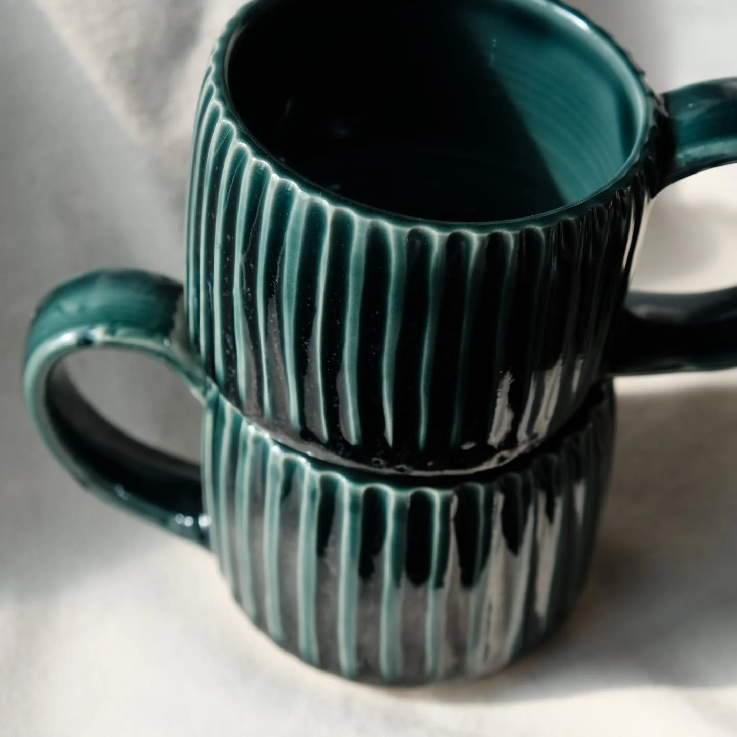 I have carved plenty of mugs but somehow it had never been at a more perfect texture than these were. Is there really anything more satisfying? 

These emerald green beauty's are available! 

#christmasgreen #emeraldgreen #carvedmug #wheelthrown