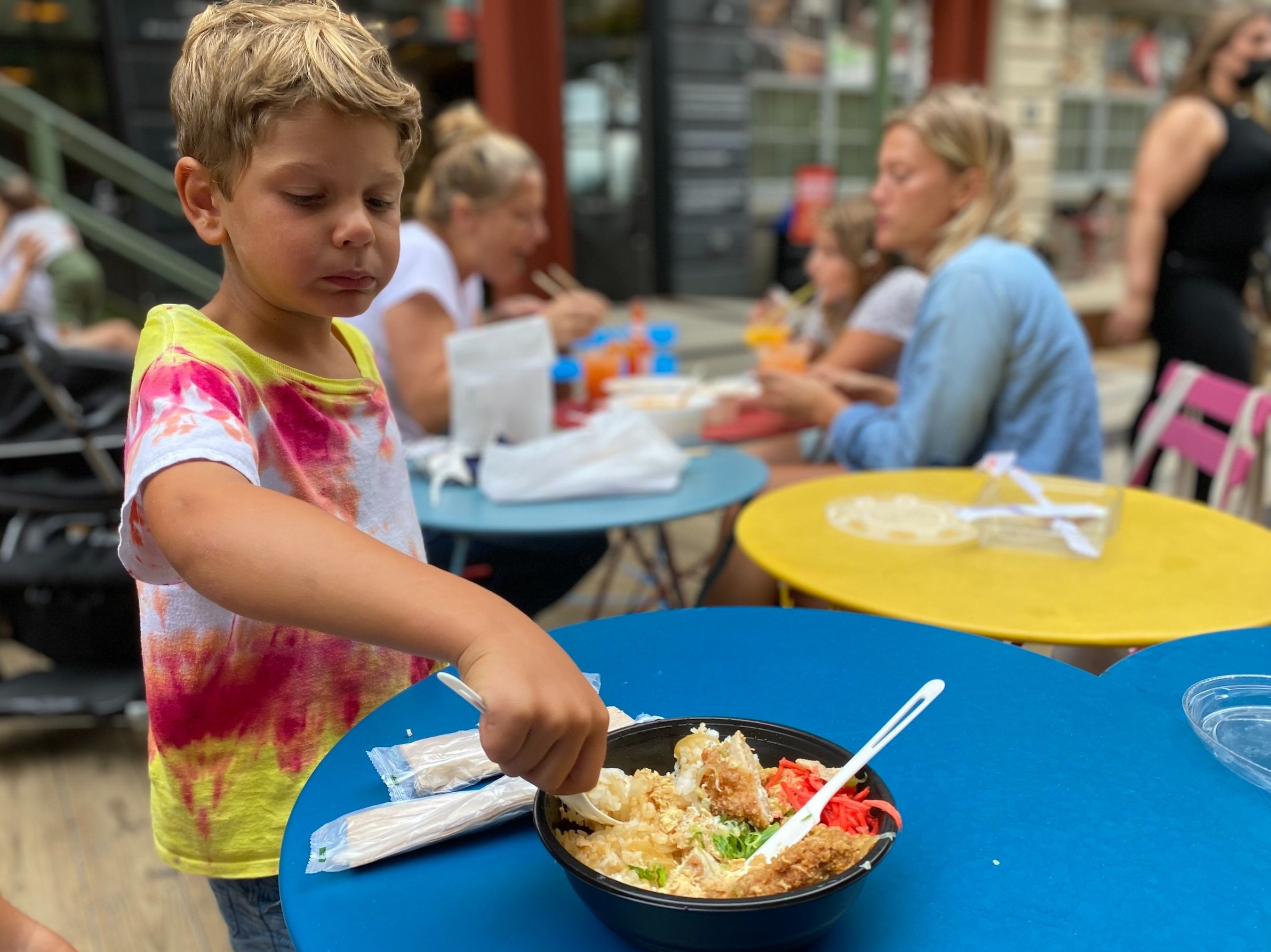 child eats Japanese noodle bowl outdoors in Brooklyn - Industry City food