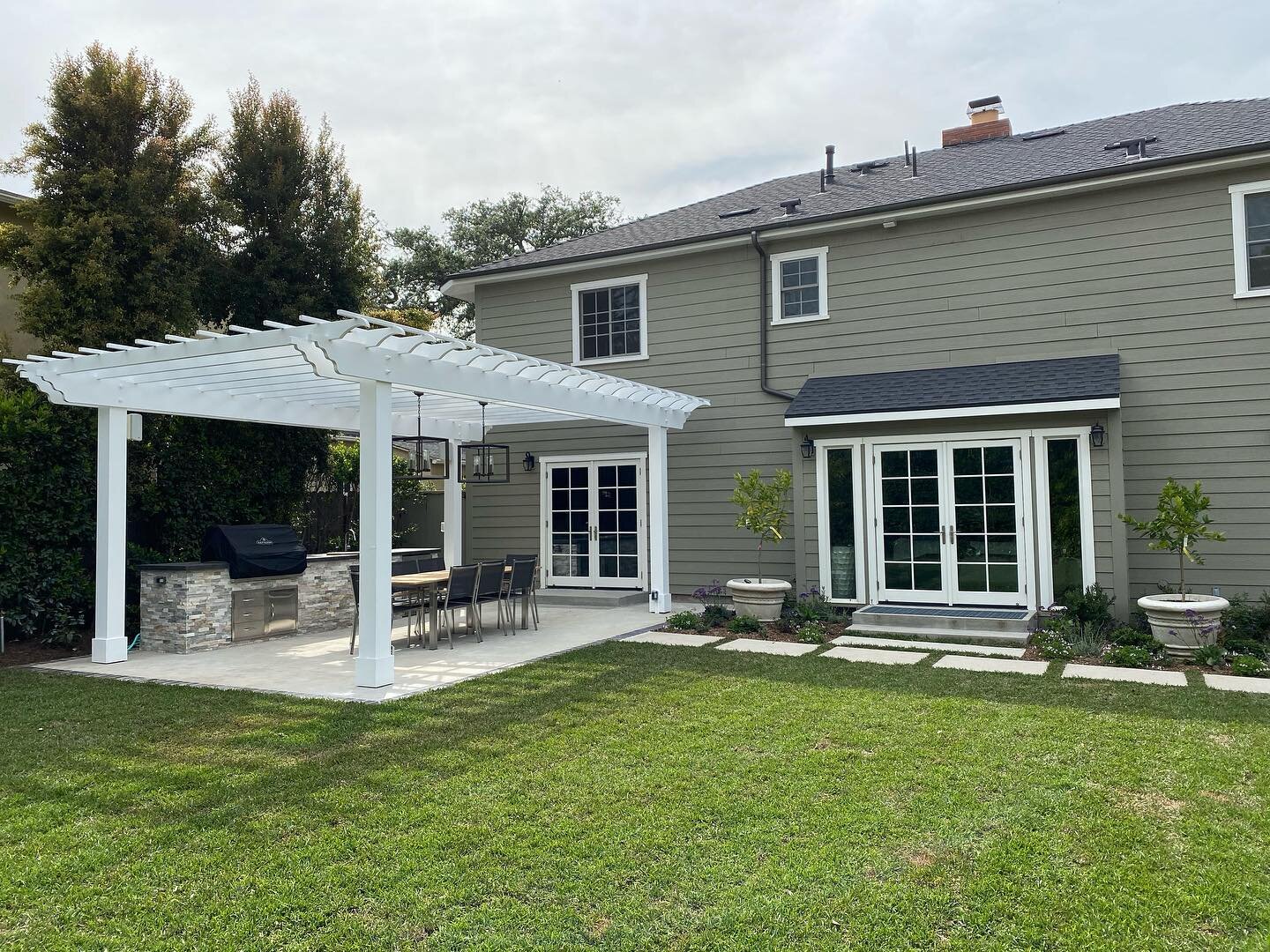 What a beautiful outdoor transformation we just completed for our clients. We custom designed and built this impressive outdoor entertainment area complete with built-in bbq &amp; a large dining table for guests. The freshly planted landscaping featu