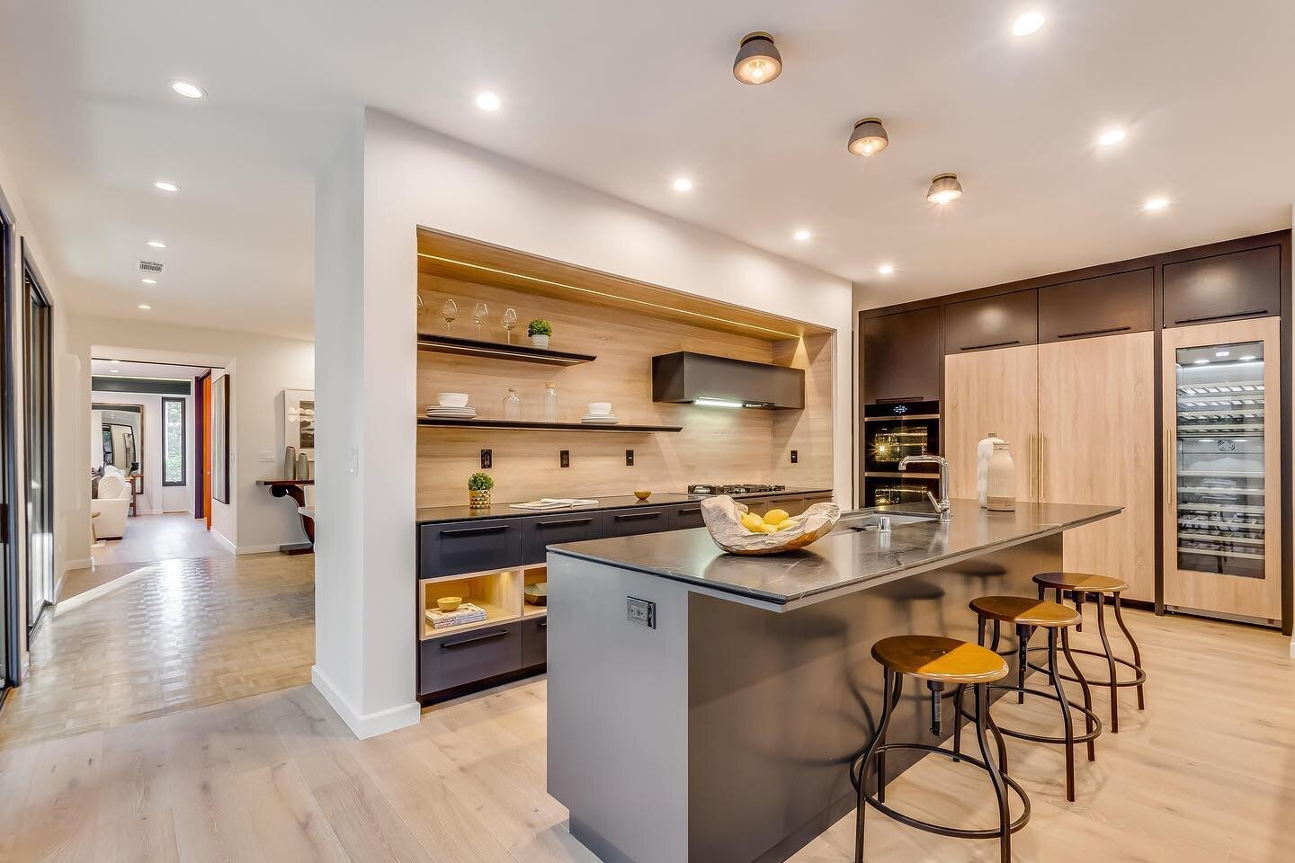 Kitchen Spotlight : Seamless Contemporary
The kitchen at 1335 Carnarvon Drive is custom-designed and marries sleek charcoal cabinets with warm wooden accents, proving modern design doesn&rsquo;t have to be sterile. Built-in appliances and a spacious 