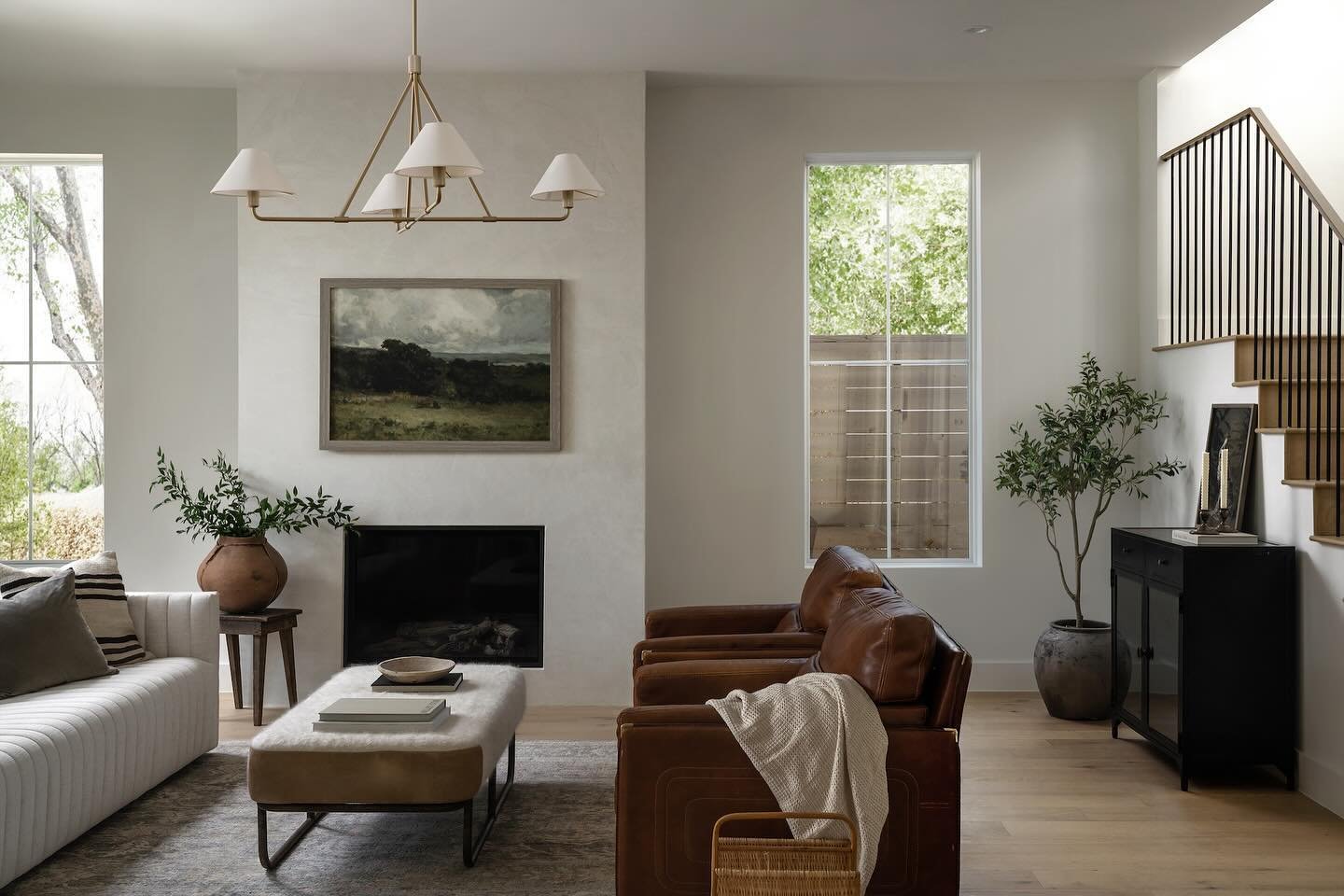 When you walk into this modern cottage, you&rsquo;re immediately greeted with an open-concept floor plan that connects the entry, dining room, living room, and kitchen. On the back wall, large slider doors create beautiful shadows and reflections tha