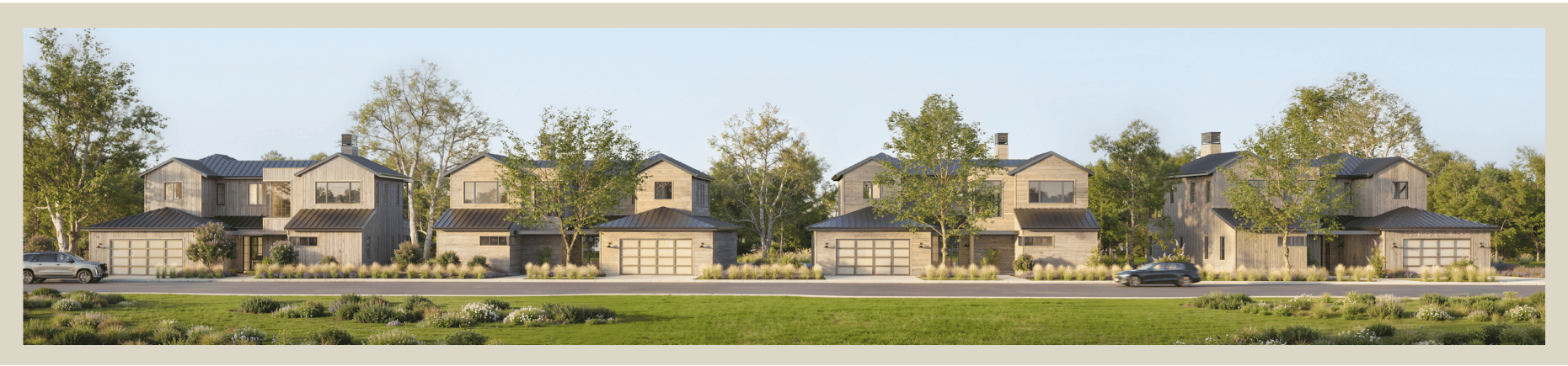 Row of modern houses with garages on a suburban street, trees, and greenery in front and background.