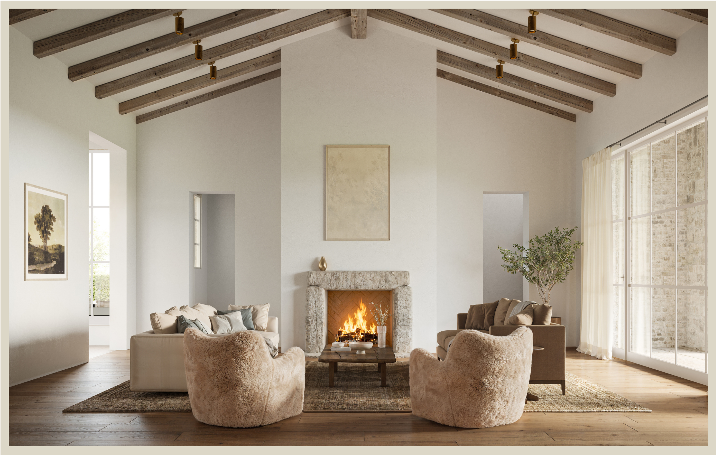Living room with white walls, wooden ceiling beams, a fireplace with a fire burning, beige armchairs, sofas with cushions, a wooden coffee table, artwork on the walls, and large windows with curtains and a view of a brick exterior.