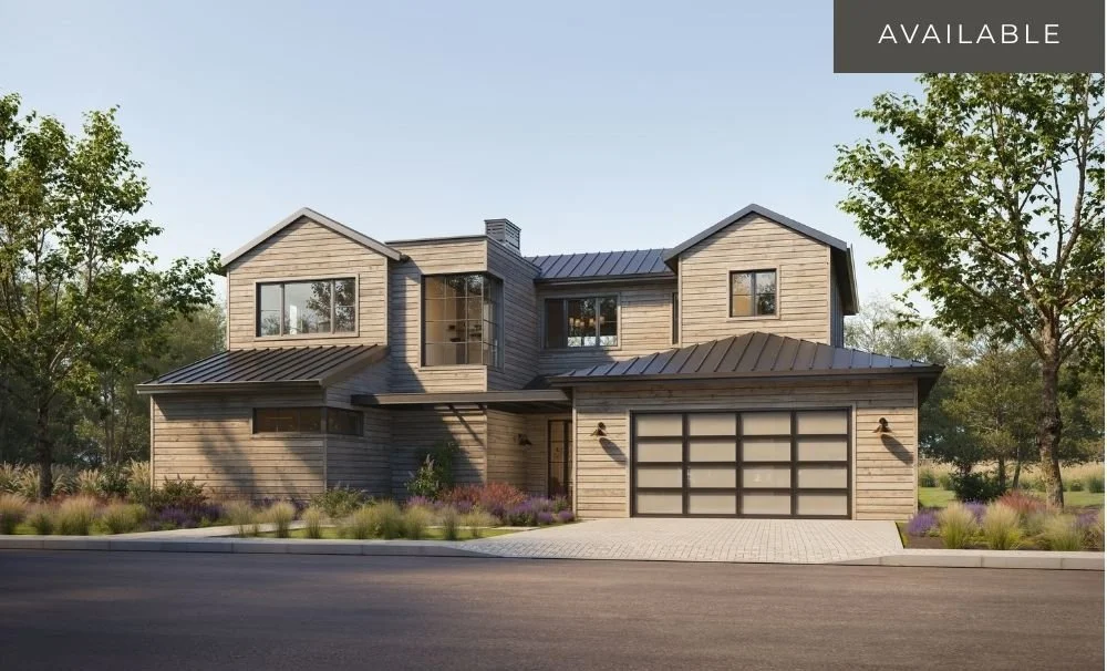 Modern two-story house with wooden exterior, large windows, a two-car garage, and landscaped yard with trees and shrubs.