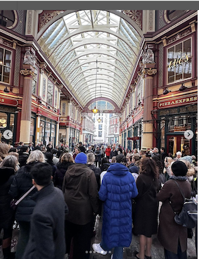 Women gathered in as a choir in Leadenhall Market