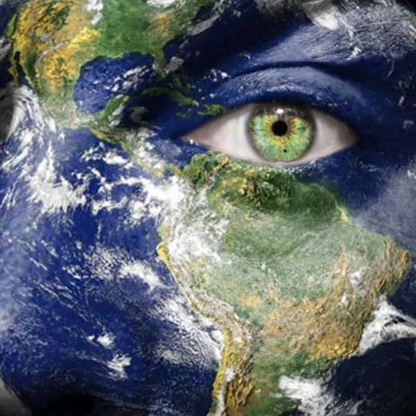 A collage of Earth with a human eye blending into the planet's surface, highlighting environmental awareness.