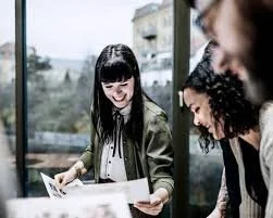 People looking at sheets of paper at a university