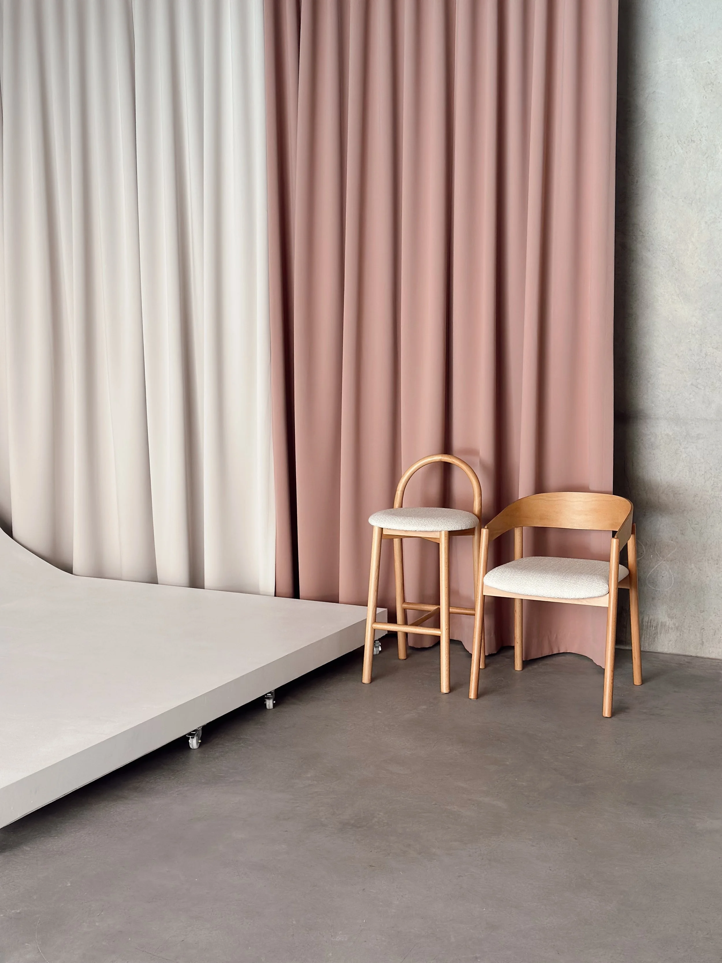 Moveable cyclorama and cream and blush curtains, creating a luxury backdrop at Sobu, a photo and content studio in Brisbane.