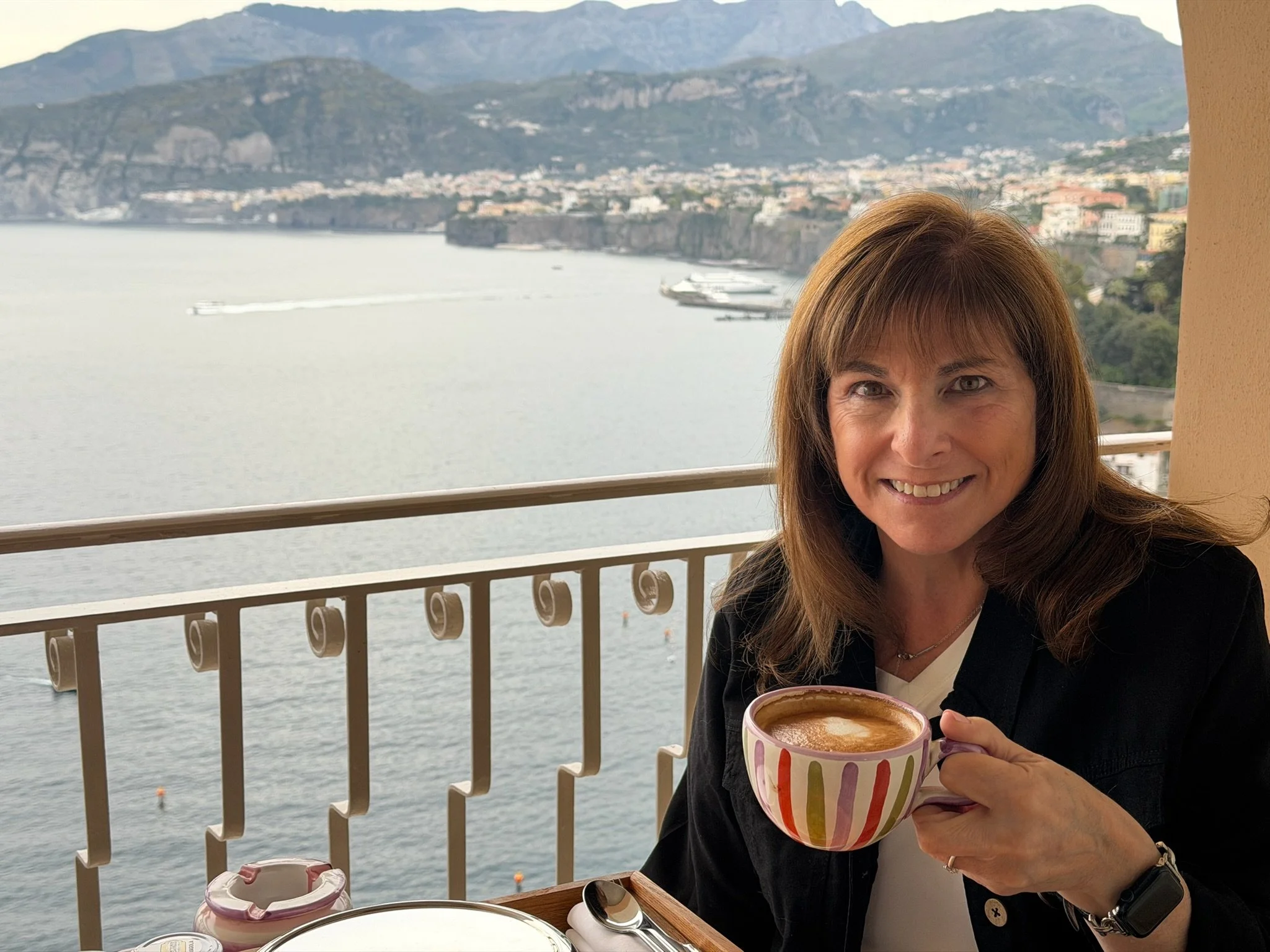 Ellen, art director and designer, enjoying coffee at a lakeside café