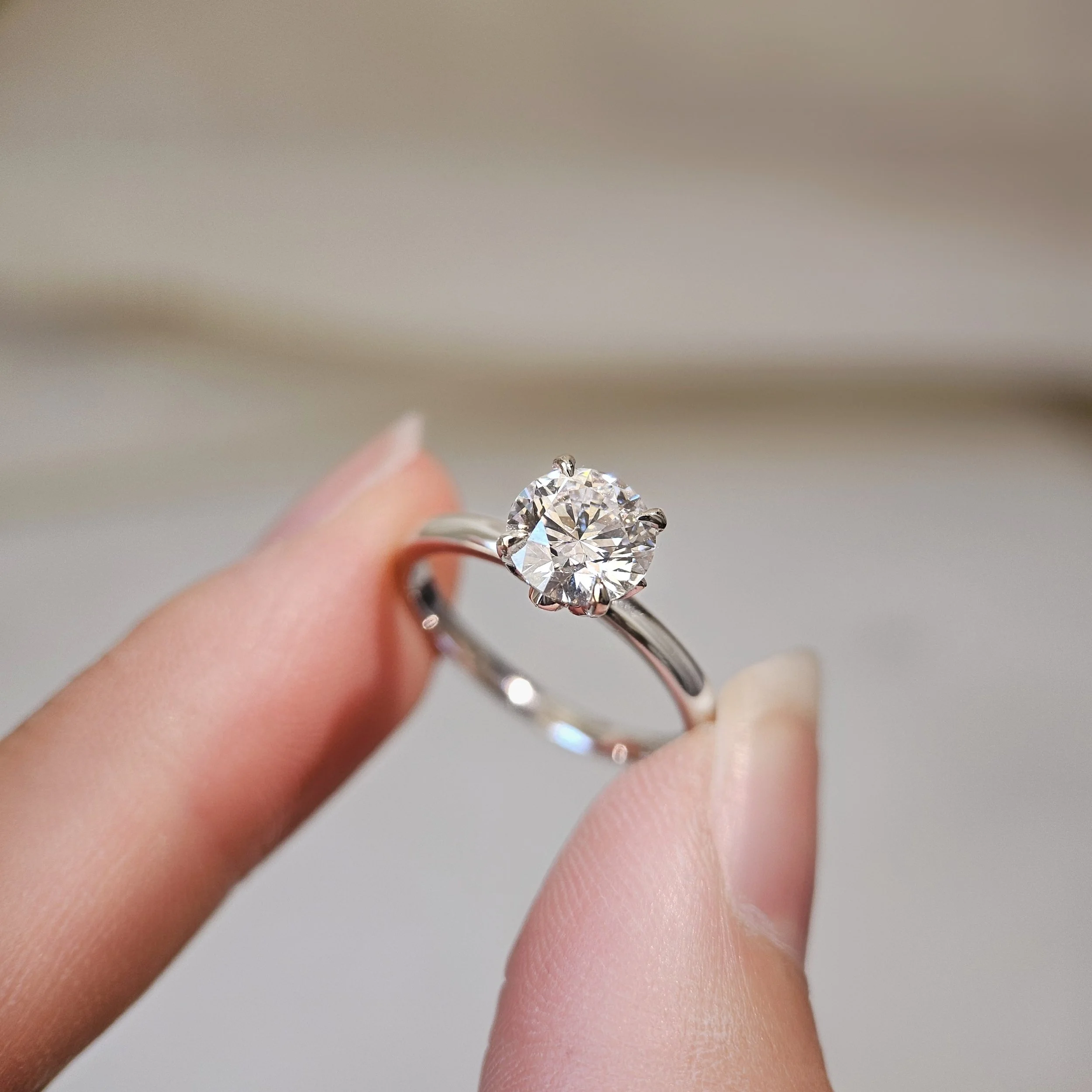 The Lotus Ring featuring an IGI-certified 1.41ct round brilliant lab-grown diamond in an 18K white gold lotus-inspired setting by Lovélle Jewellery