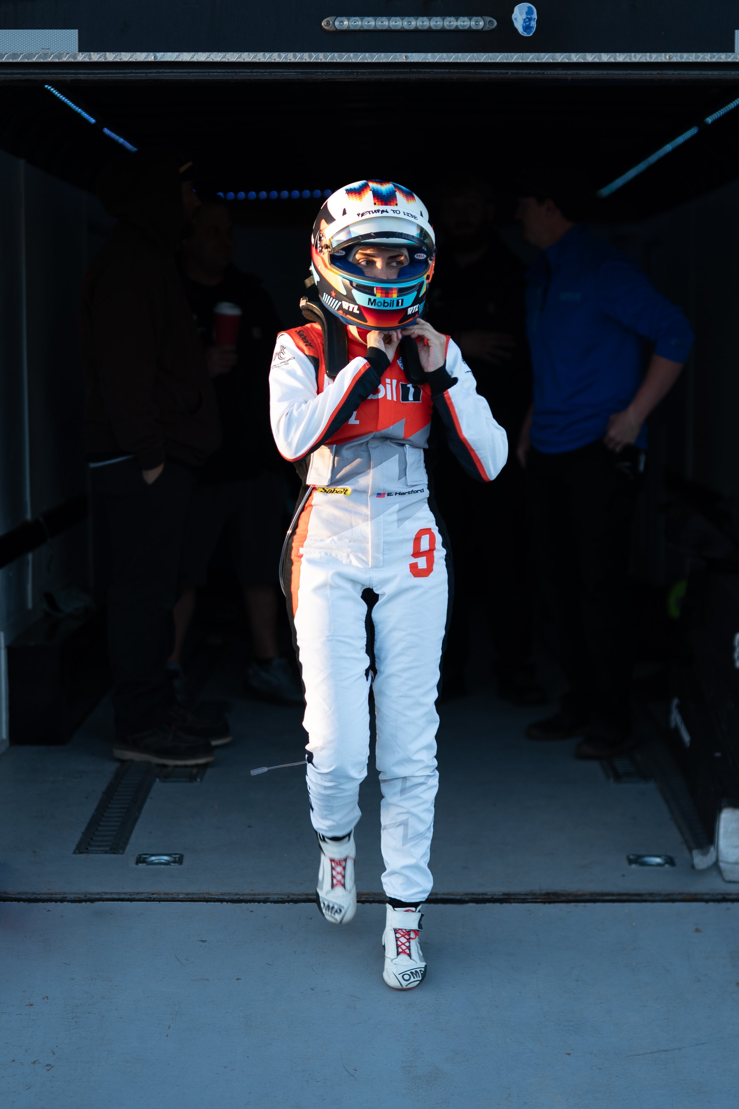 Emelia Hartford suiting up to race her Chevrolet Corvette ZR1 up Pikes Peak International Hill Climb