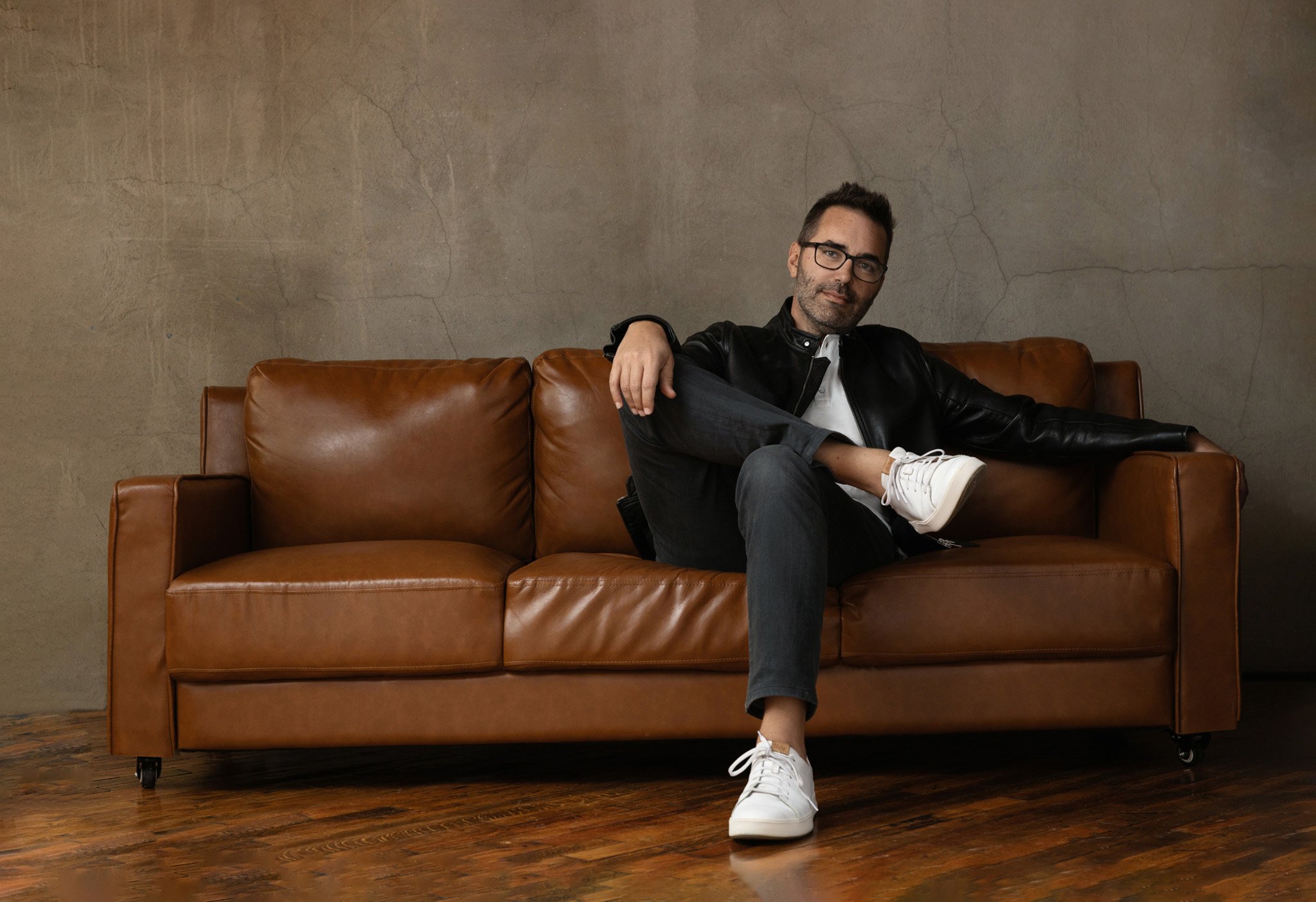 Nashville branding portrait of a man seated on a leather couch by Judith Hill Photography