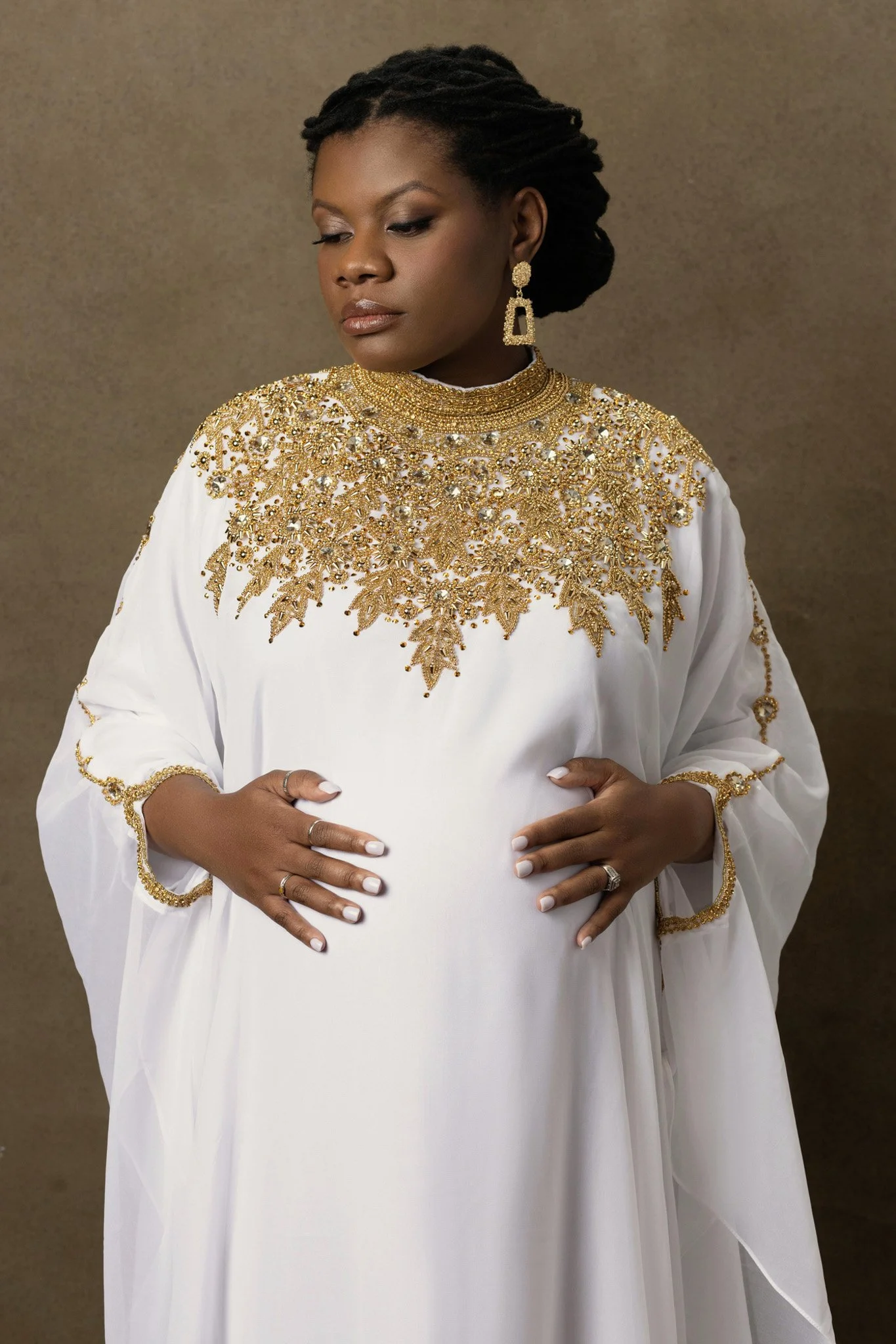 Black woman in a white and gold beaded gown cradling her belly, Nashville generations portrait by Judith Hill