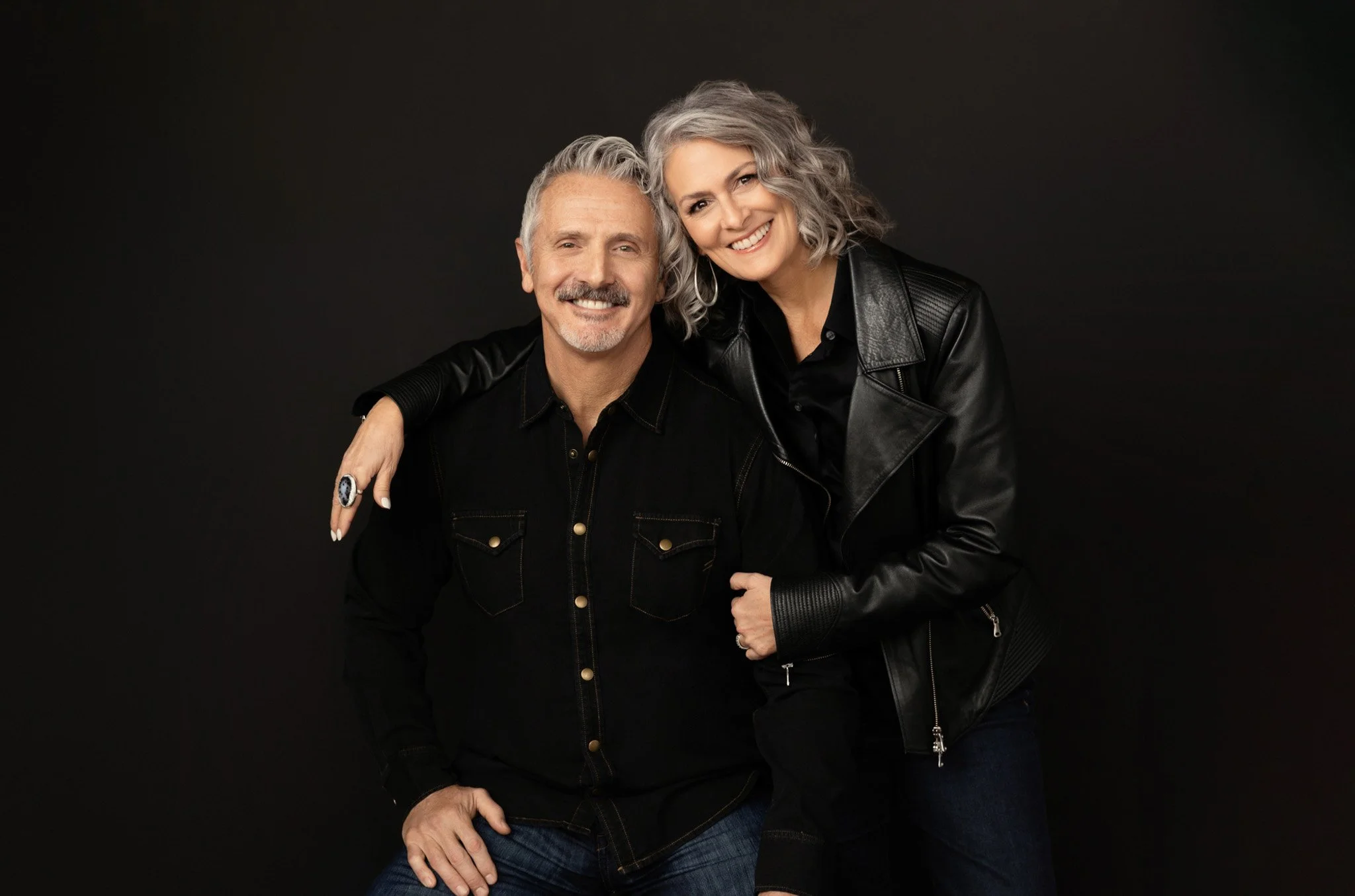 Couple in black embracing and smiling, Nashville couples portrait by Judith Hill