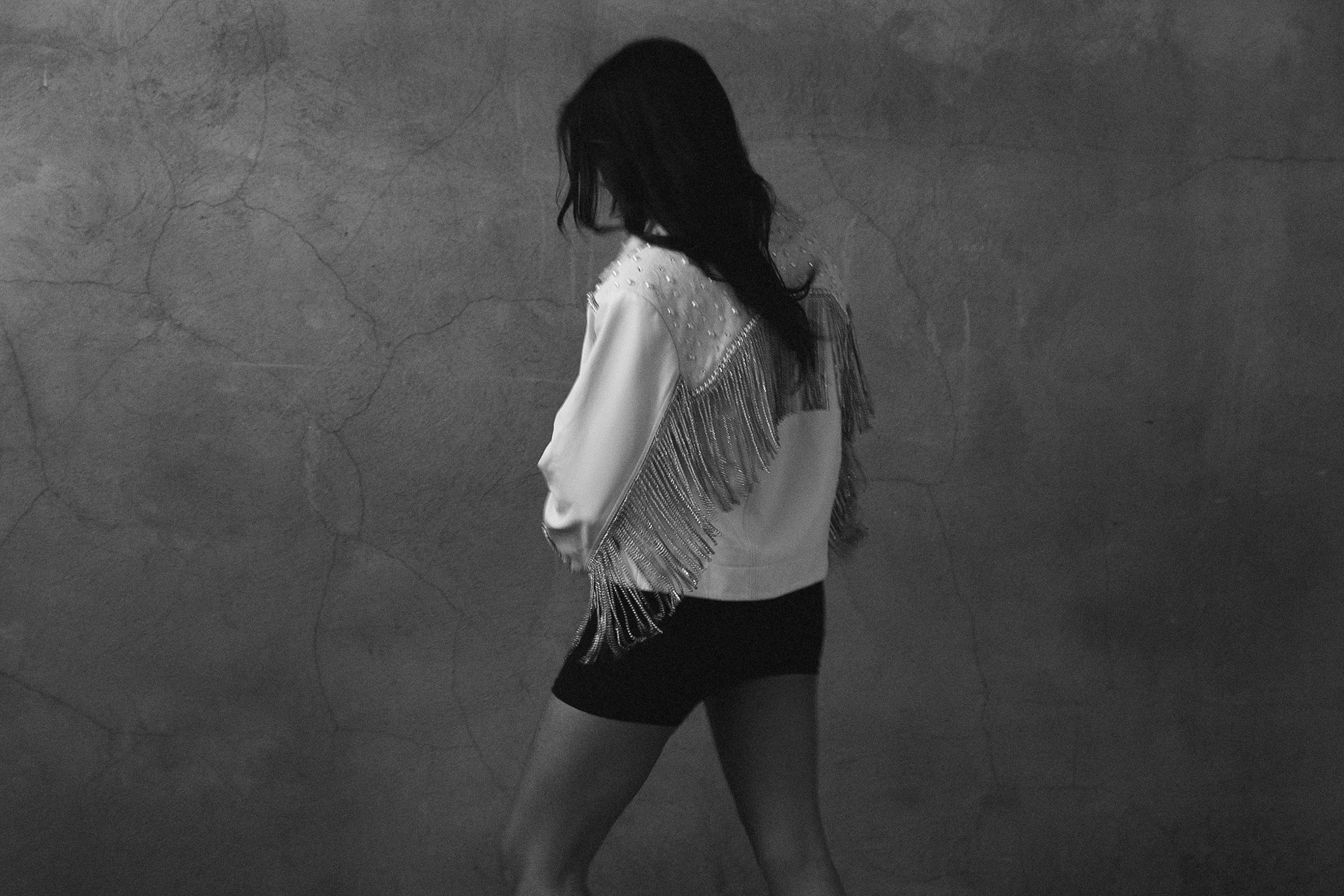 Black-and-white portrait of a woman in a white fringe jacket, Nashville editorial portrait by Judith Hill