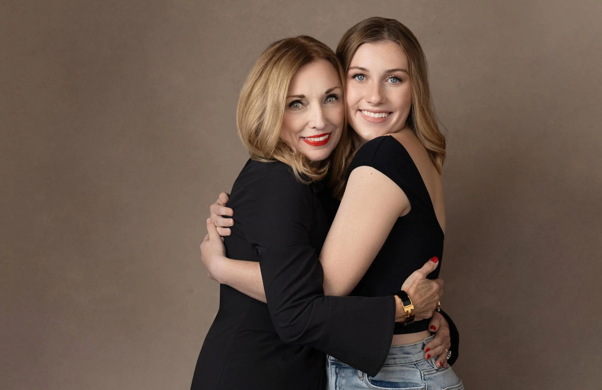 Mother and teen daughter embracing against a taupe backdrop, Nashville generations portrait by Judith Hill