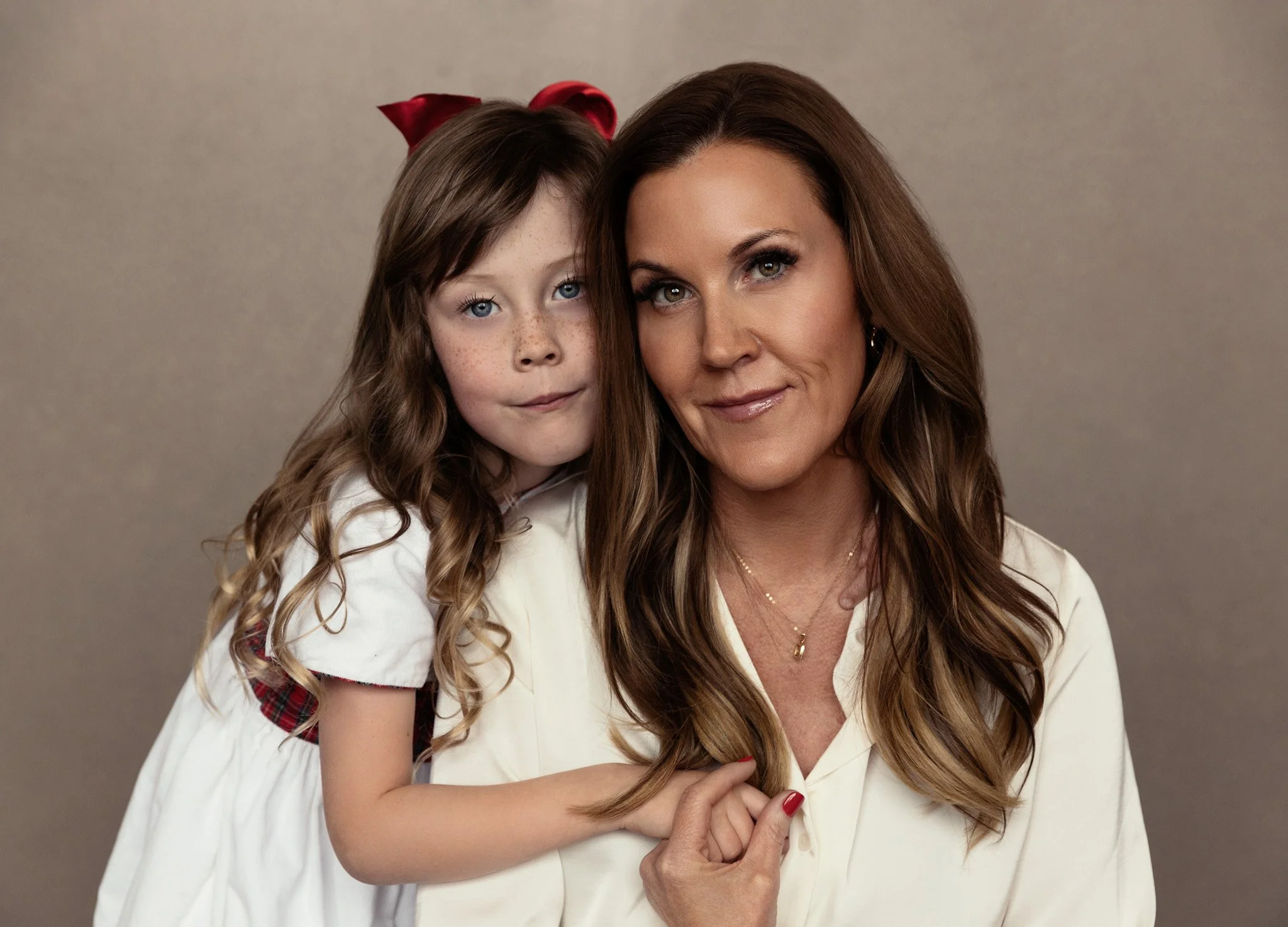 Mother and young daughter cheek to cheek in cream tones, Nashville generations portrait by Judith Hill