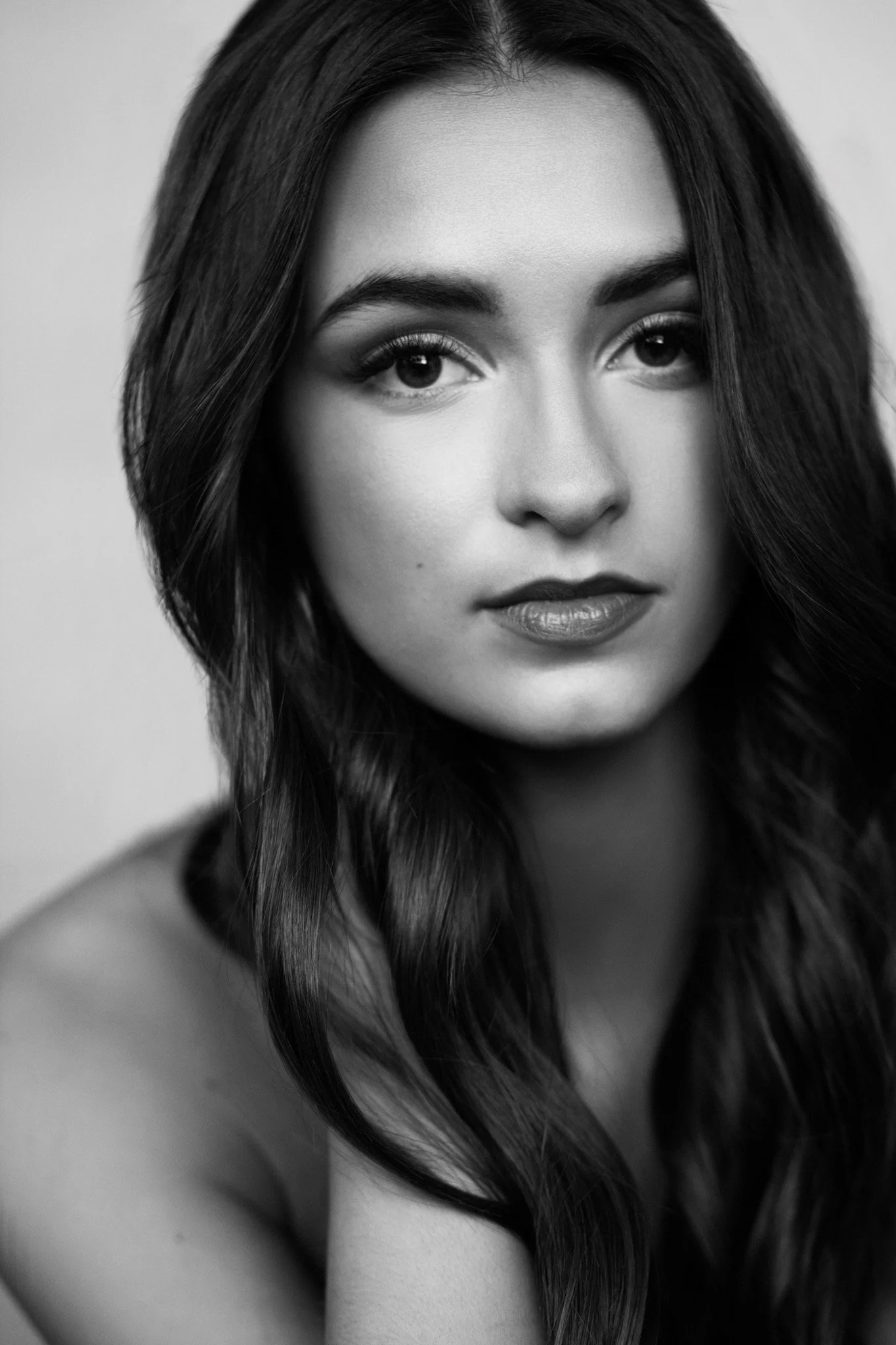 Black-and-white beauty headshot of a young woman with dark hair, Nashville portrait by Judith Hill