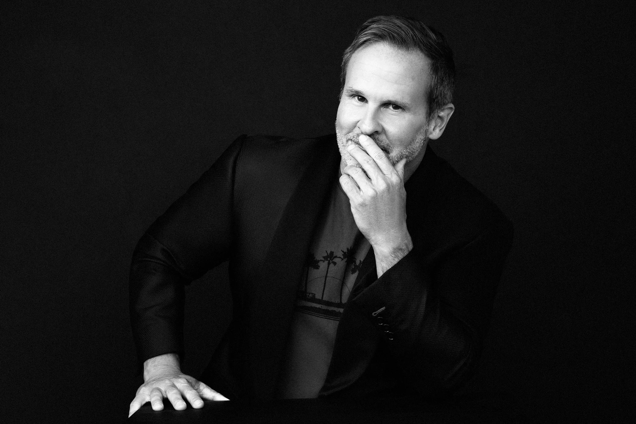 Black-and-white portrait of a man in a blazer with his hand to his face, Nashville men's portrait by Judith Hill