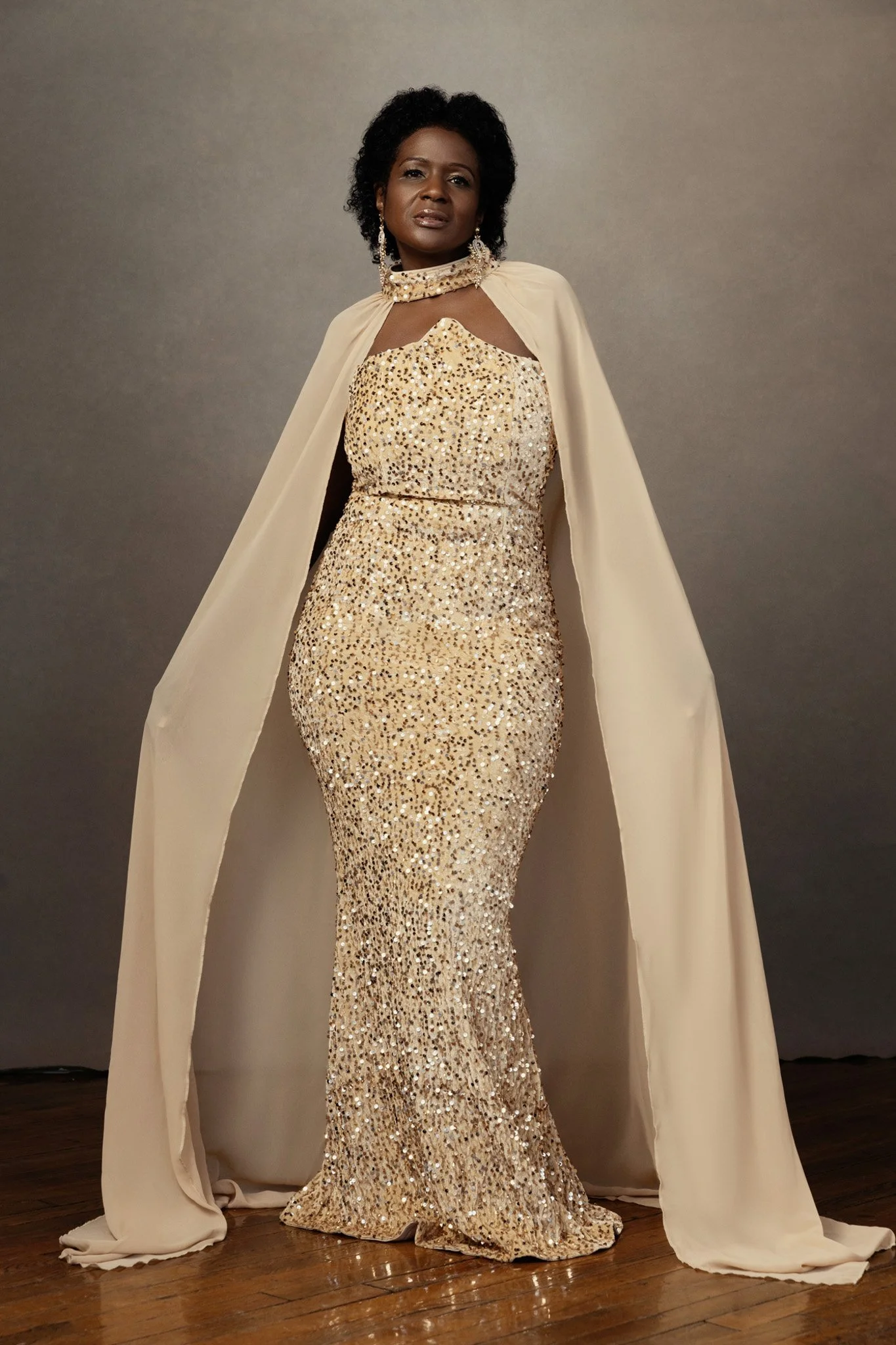 Black woman in a gold sequin gown with a flowing cape, Nashville glamour portrait by Judith Hill