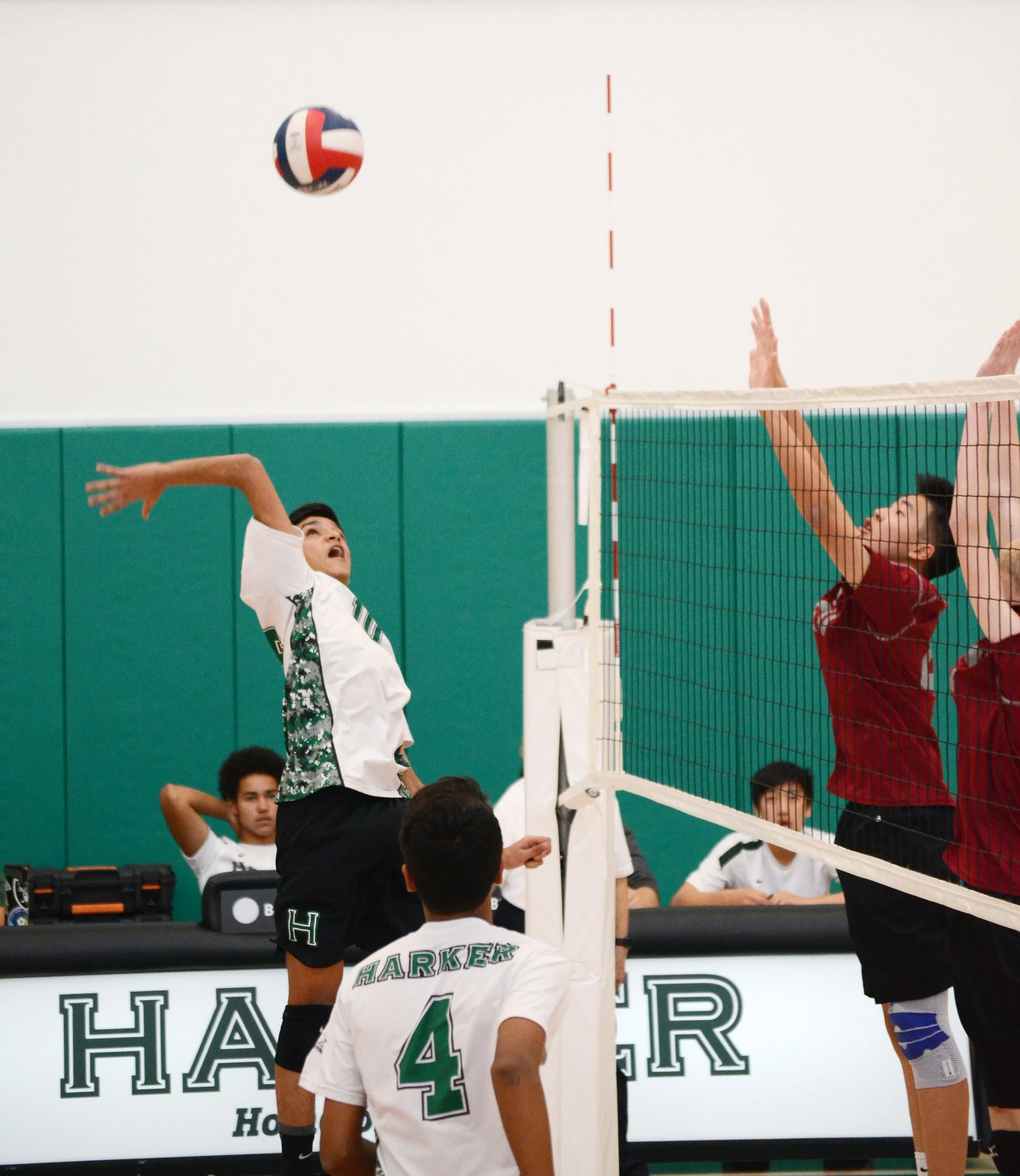 A Harker volleyball player looks up, preparing to spike the ball between two blockers. The boy’s volleyball team lost to Monta Vista High School in the NorCal Division I finals. Photo by Eric Fang
