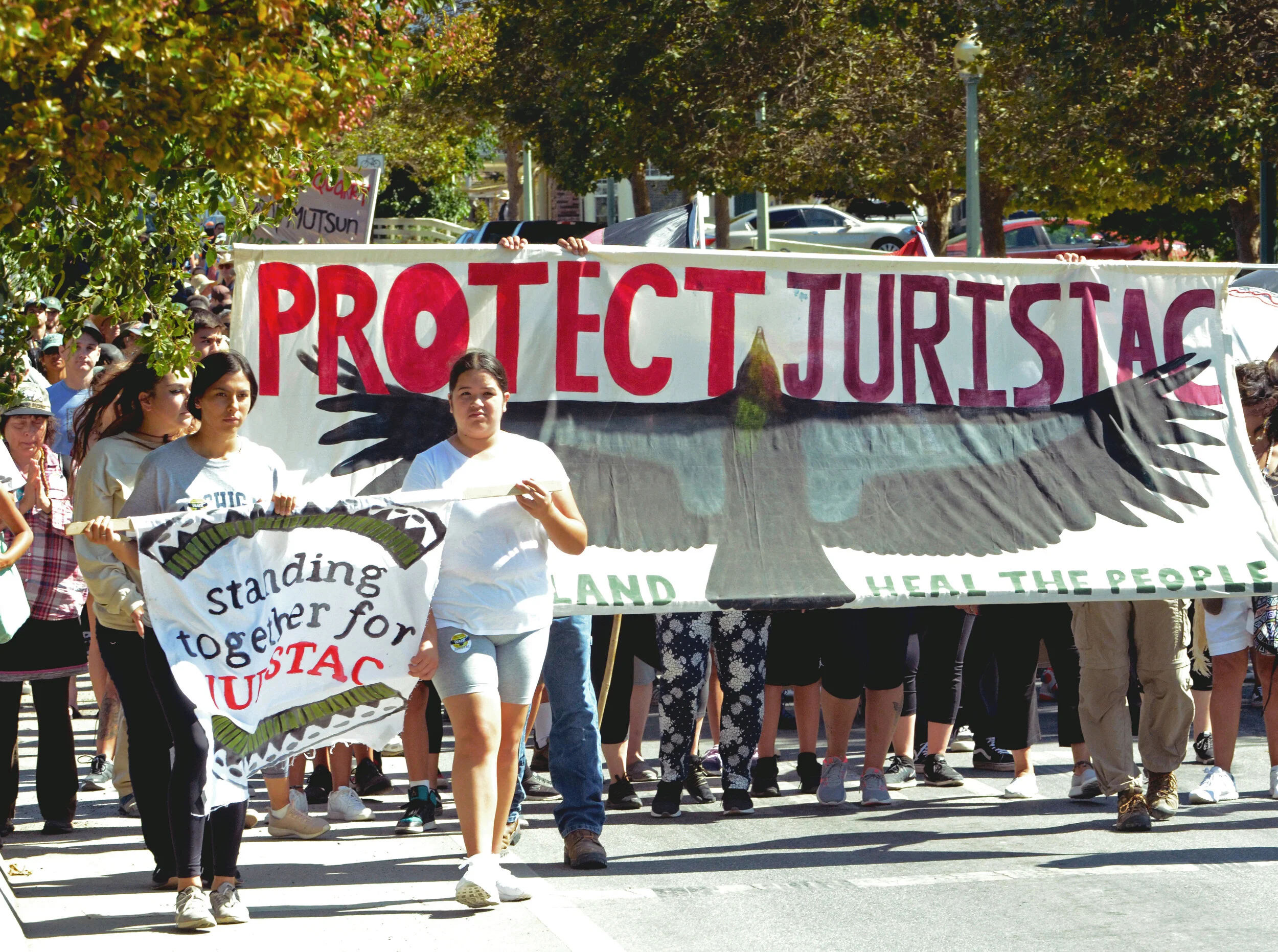 Roxanne Gaona, a senior at Central High School in Fresno, and another youth activist hold a banner reading "Standing Together for Juristac" at the front of a Sept. 8 march protesting the proposed construction of a quarry at Sargent Ranch. Local envi…