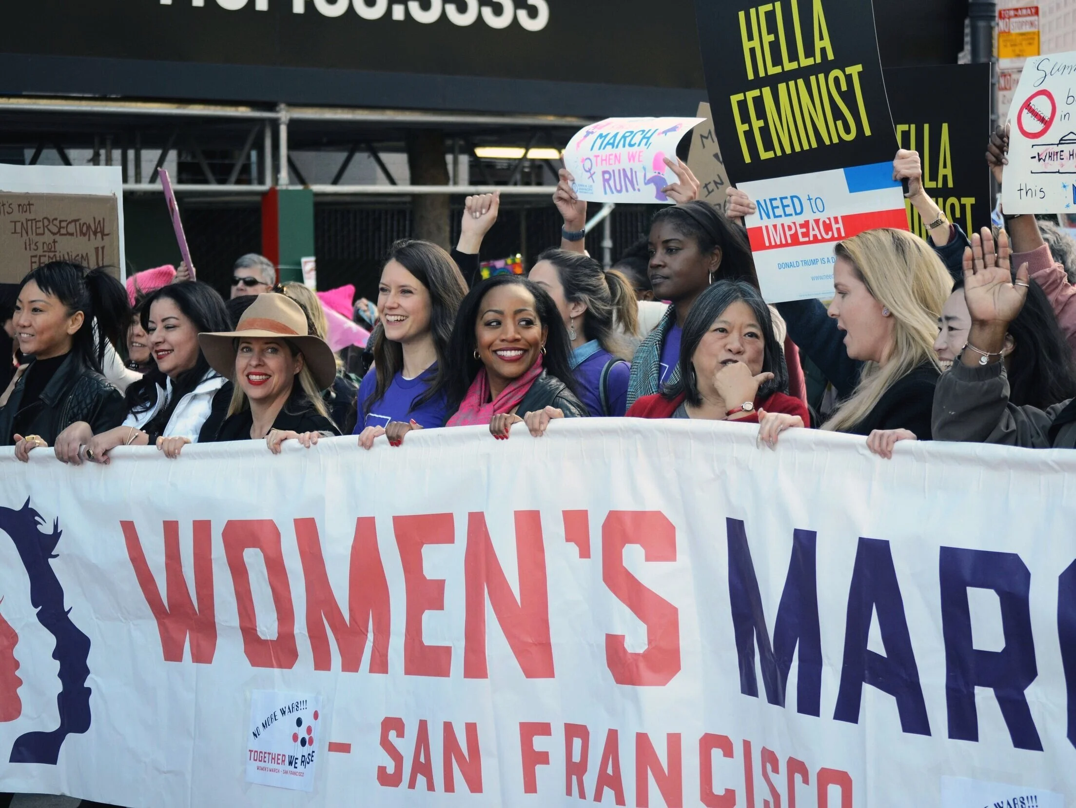 Activists, including Malia Cohen, the chair of the Board of Equalization in the 2nd District, bear the Women’s March banner down Market Street. Photo by Eric Fang