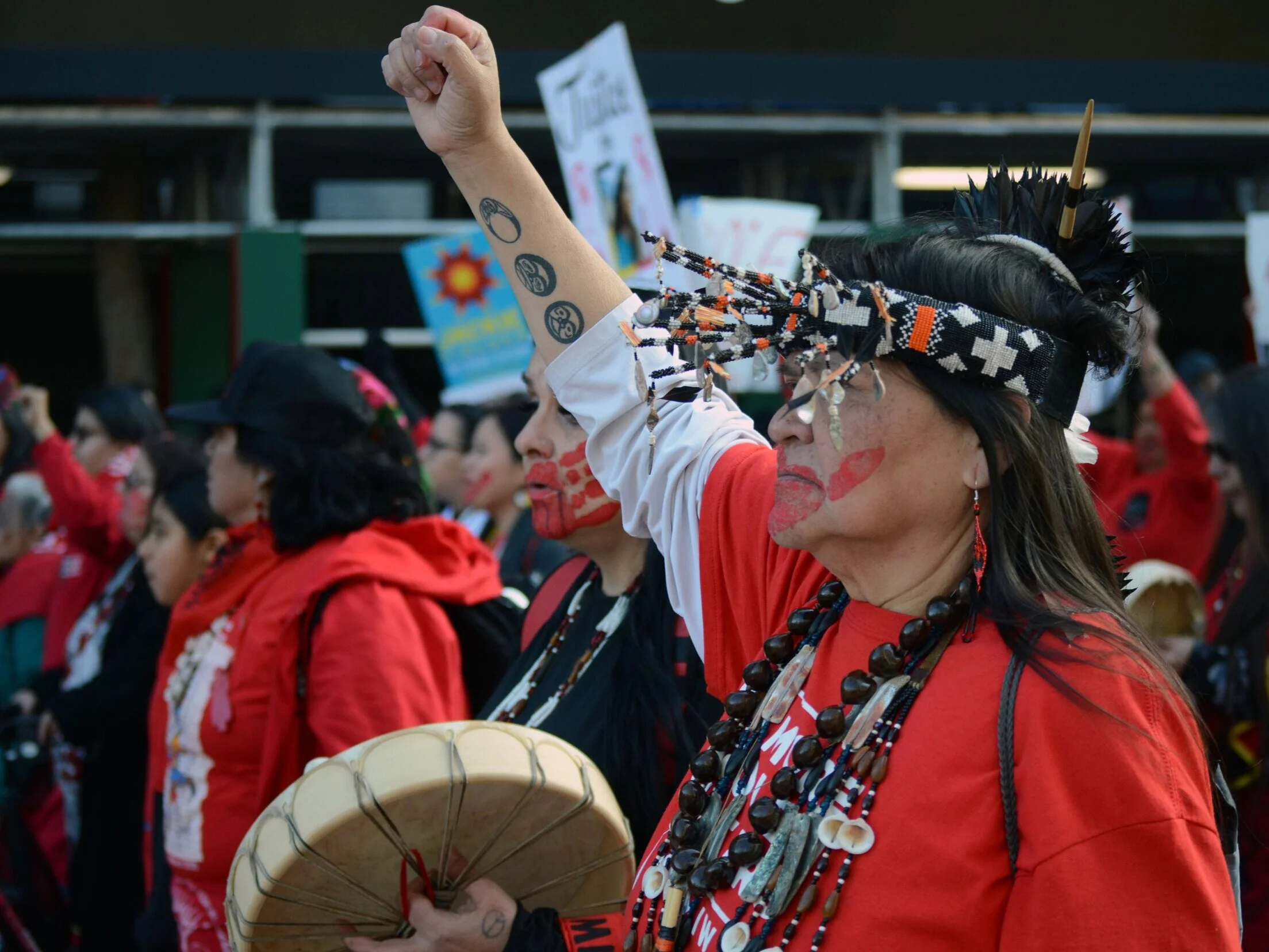 An activist from the Murdered and Missing Indigenous Women (MMIW) coalition raises her fist in solidarity as she marches down Market Street during the San Francisco Women’s March on January 18, 2020. MMIW members opened the rally and and addressed t…