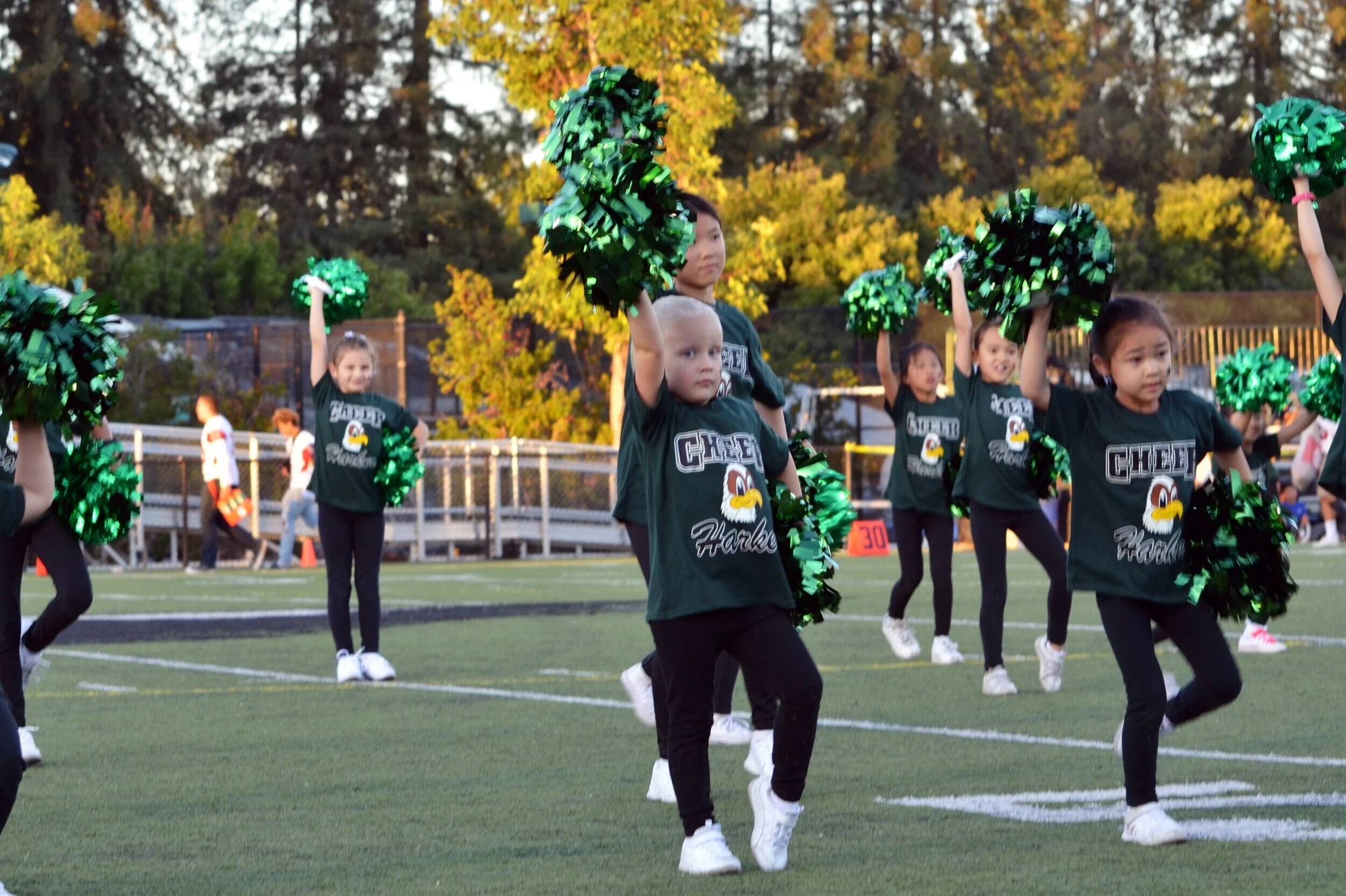 Lower school cheerleaders, also called eaglets, perform before the annual Homecoming game. The eaglets performed after a routine by the upper school’s cheer team. Photo by Eric Fang
