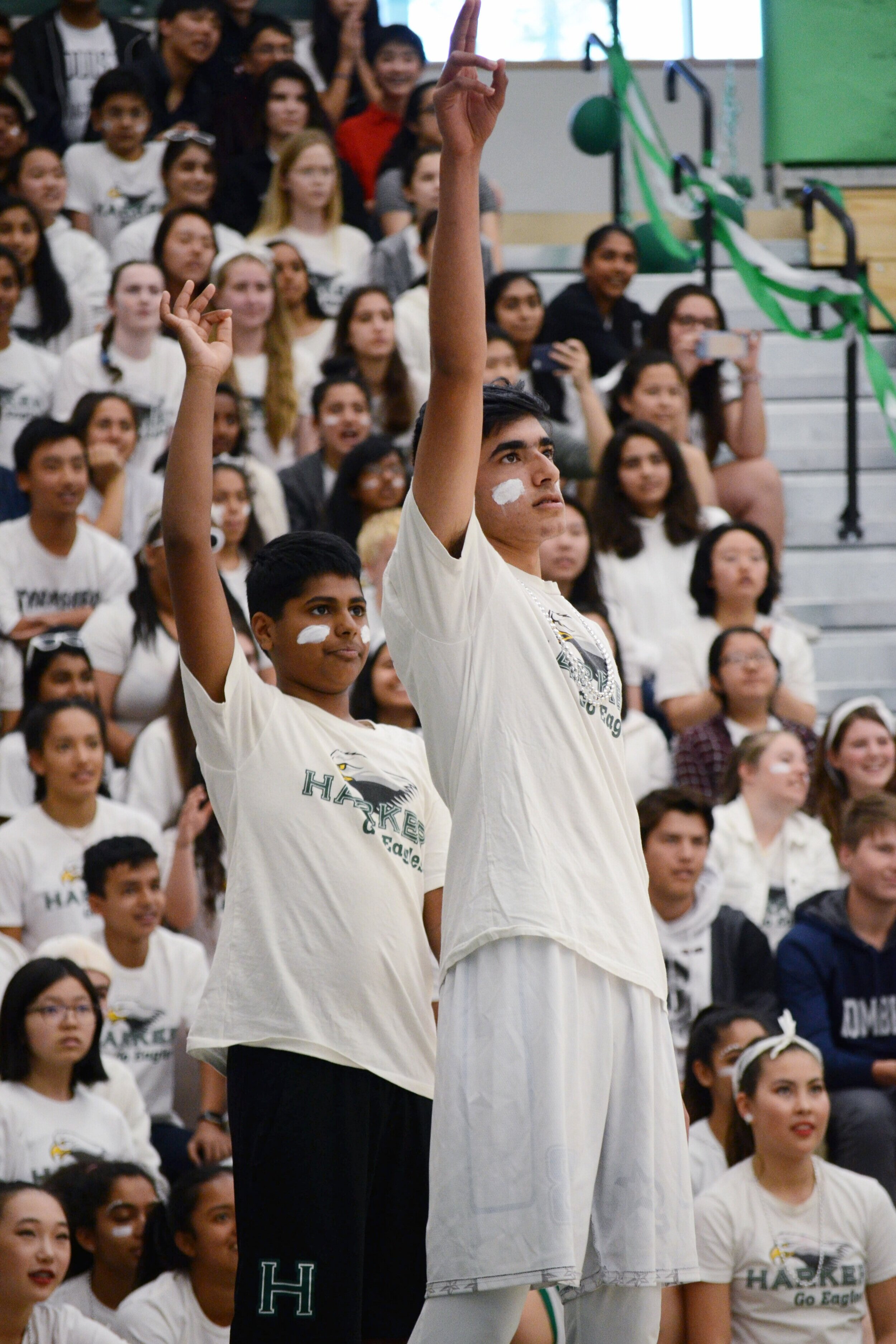 Two freshmen hold up their hands in an “OK” sign during a basketball shoot-off competition between classes. The freshman class placed last in spirit points at the end of the year. Photo by Eric Fang