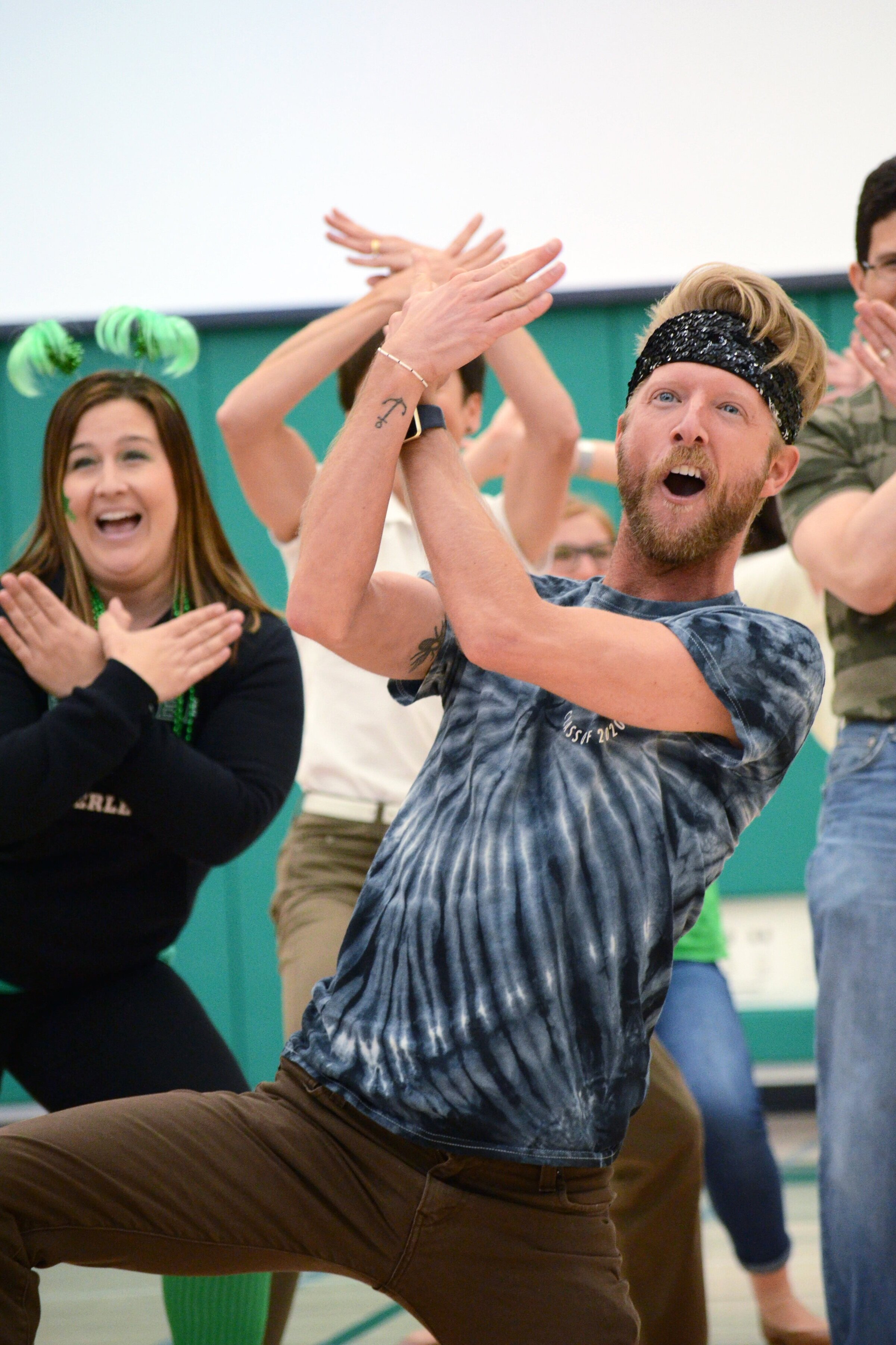 Sophomore Class Dean Karl Kuehn dances with other staff members during the spring spirit rally of 2018. Kuehn also teaches several dance classes throughout the week. Photo by Eric Fang