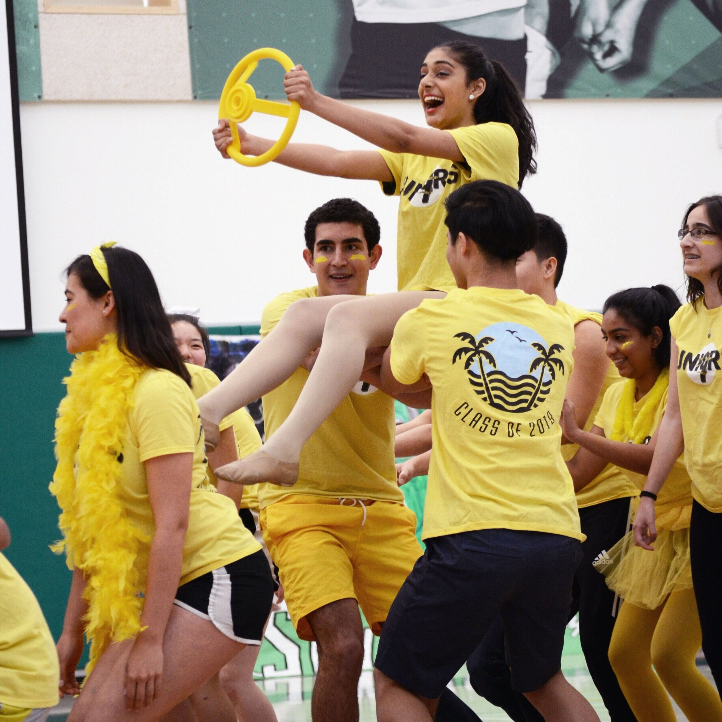A junior pretends to drive a car as she is held up by other classmates. The juniors placed second in spirit points by the end of the year. Photo by Eric Fang