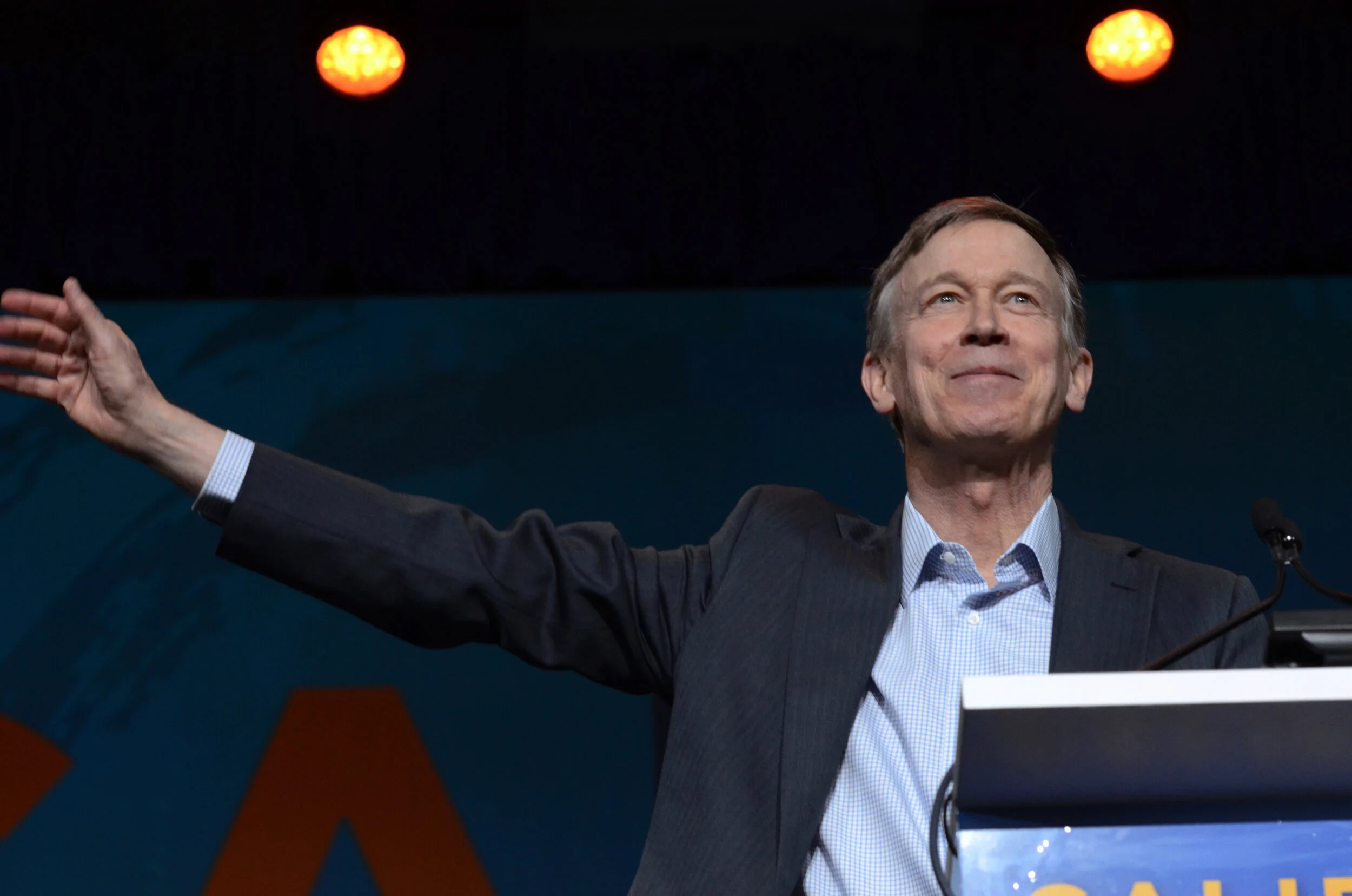 Gov. John Hickenlooper (D-Colo.) raises his arm following his speech at the California Democratic State Convention on June 1, 2019. Hickenlooper spoke out against universal healthcare plans championed by Sen. Bernie Sanders (I-Vt.). Photo by Eric Fa…