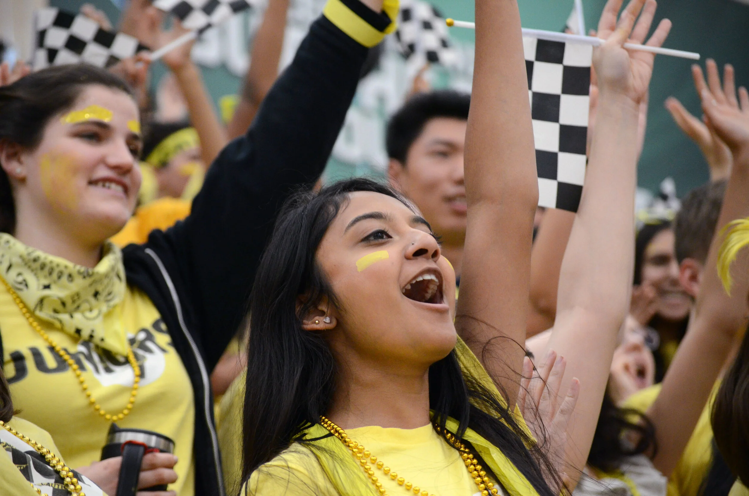 A junior shouts approval as several of her classmates compete in a basketball tournament. The juniors placed third in the tournament. Photo by Eric Fang