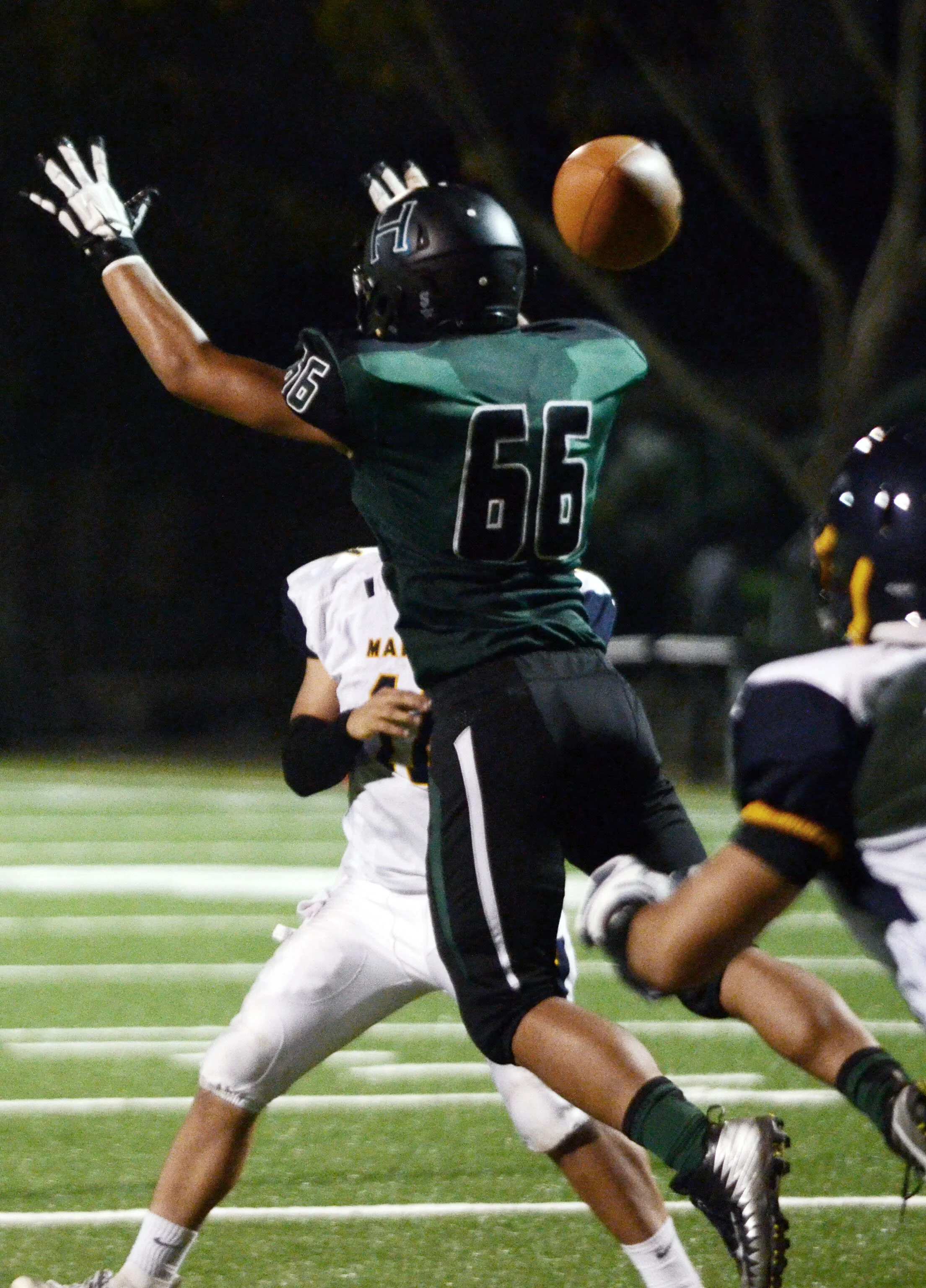 A Harker receiver jumps and barely misses a throw from the quarterback during a home game against Marina High School. Harker’s record improved to 3-1 after defeating Marina on Sept. 6, 2018. Photo by Eric Fang