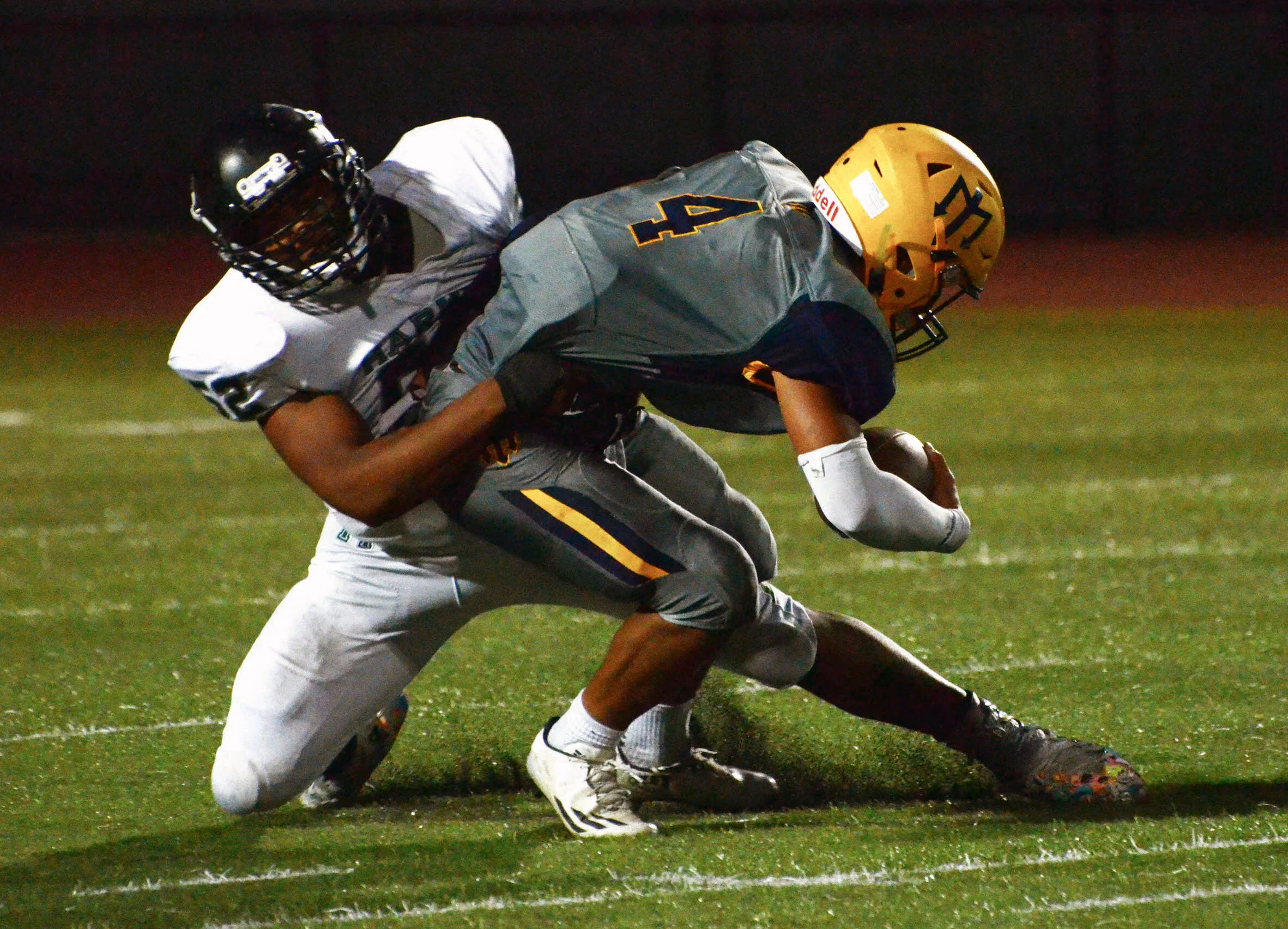 A Harker tight end tackles a Marina High School receiver during a football game at Marina High School on Sept. 29, 2017. Eighteen seniors played for Harker football during the 2017-2018 season. Photo by Eric Fang