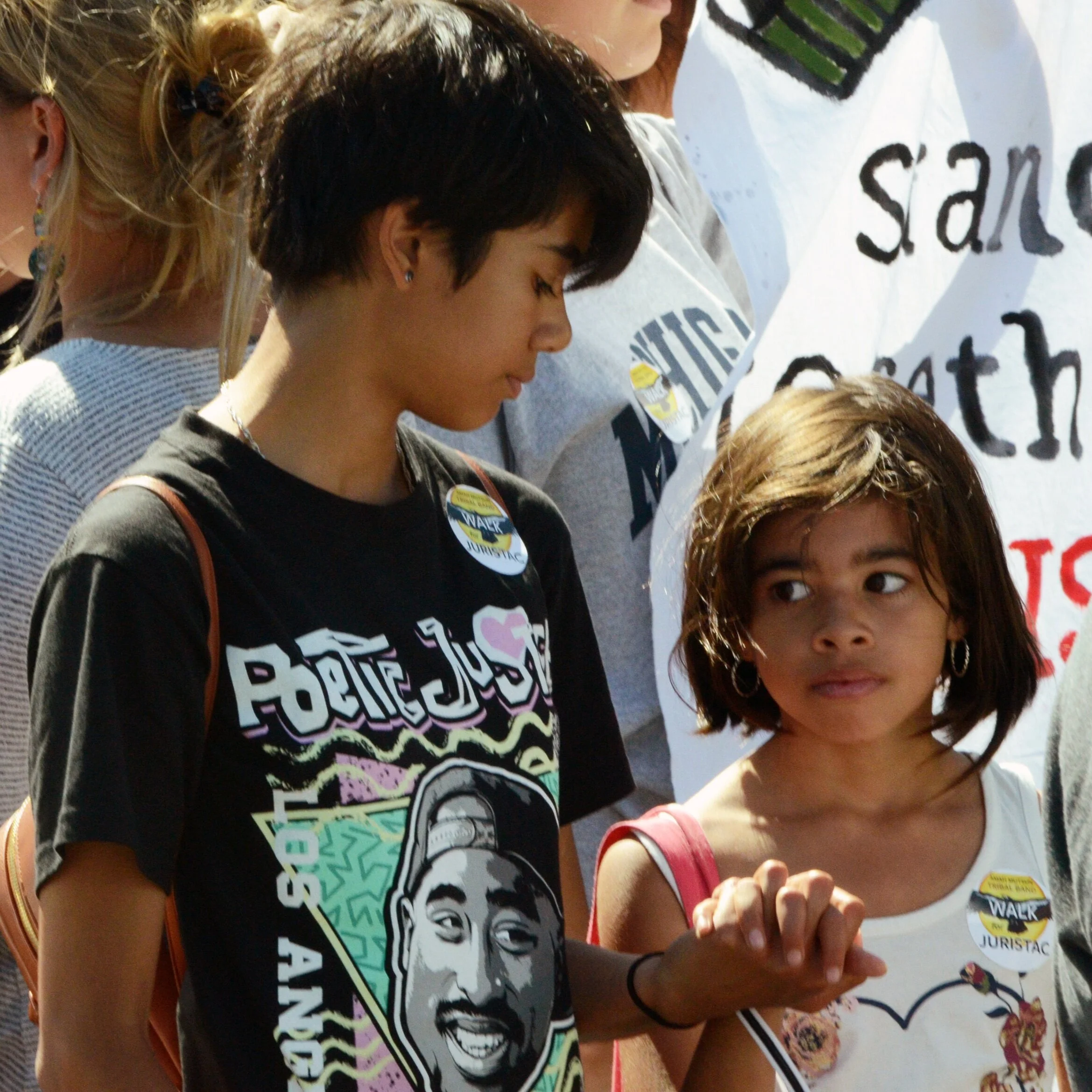 Two children hold hands prior to the start of the Amah Mutsun’s march to protest a mine being built on their sacred land. Three Native American teenagers gave a speech condemning what they said to be a destructive quarry project during the afternoon…