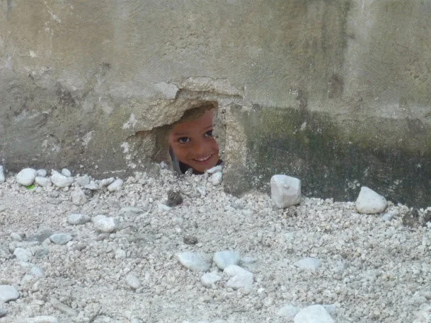 Haiti Boy Through Hole.JPG