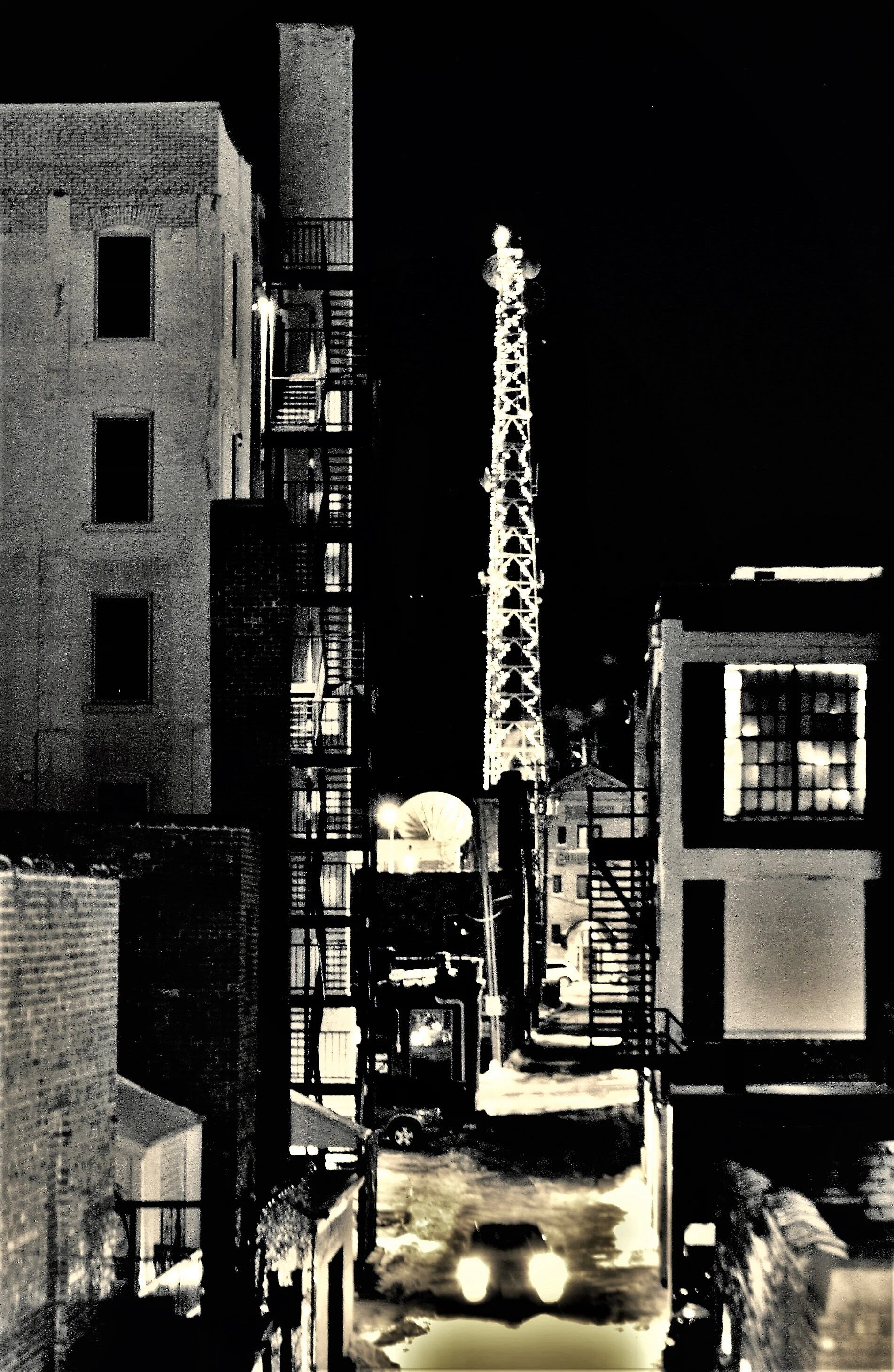  Cityscape with alley and communication tower in the background. 