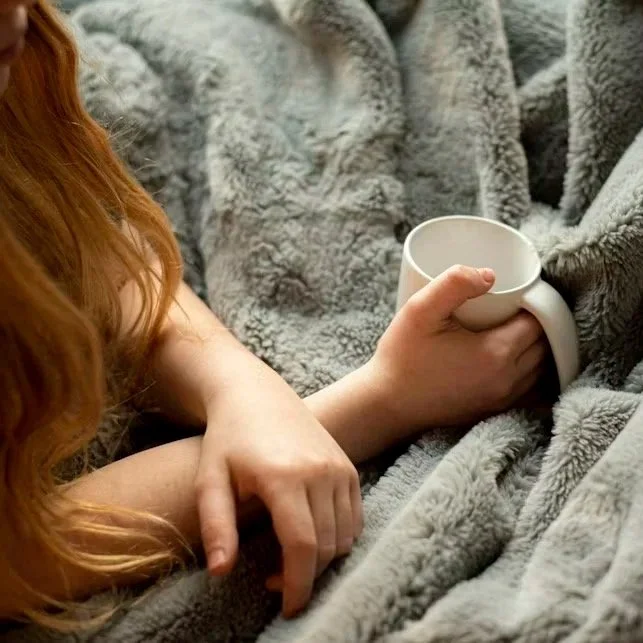 Woman in Toronto and Vaughan therapy session holding warm mug to support trauma psychotherapy