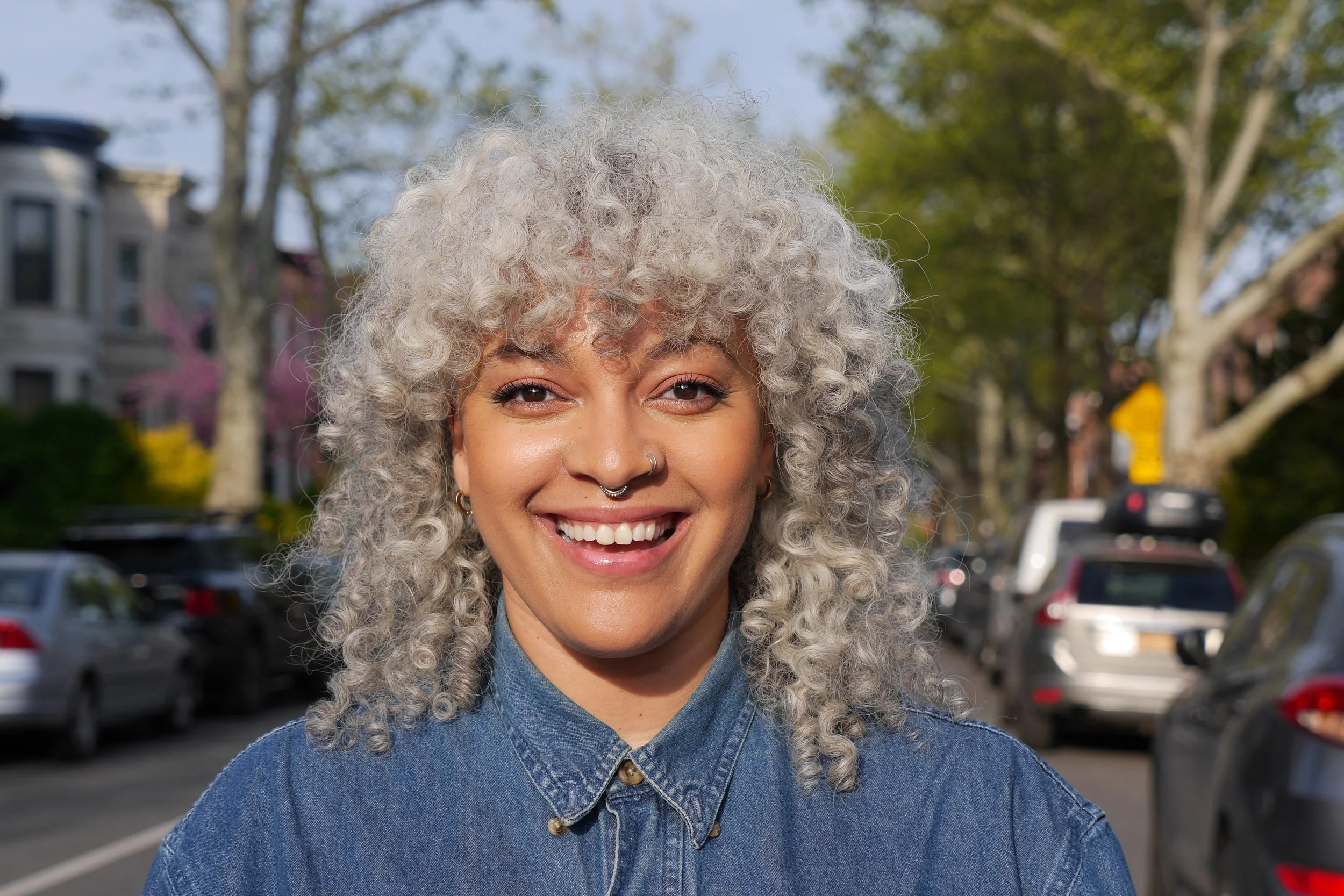Smiling woman with silver curly hair