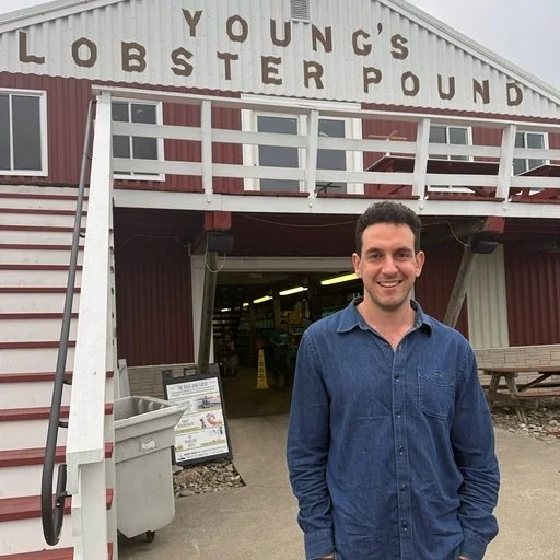 Man smiling in front of lobster shack
