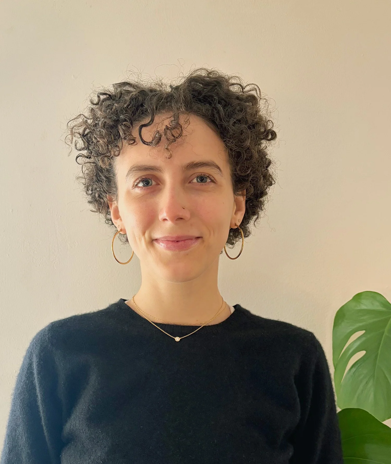 woman with curly hair smiling at camera