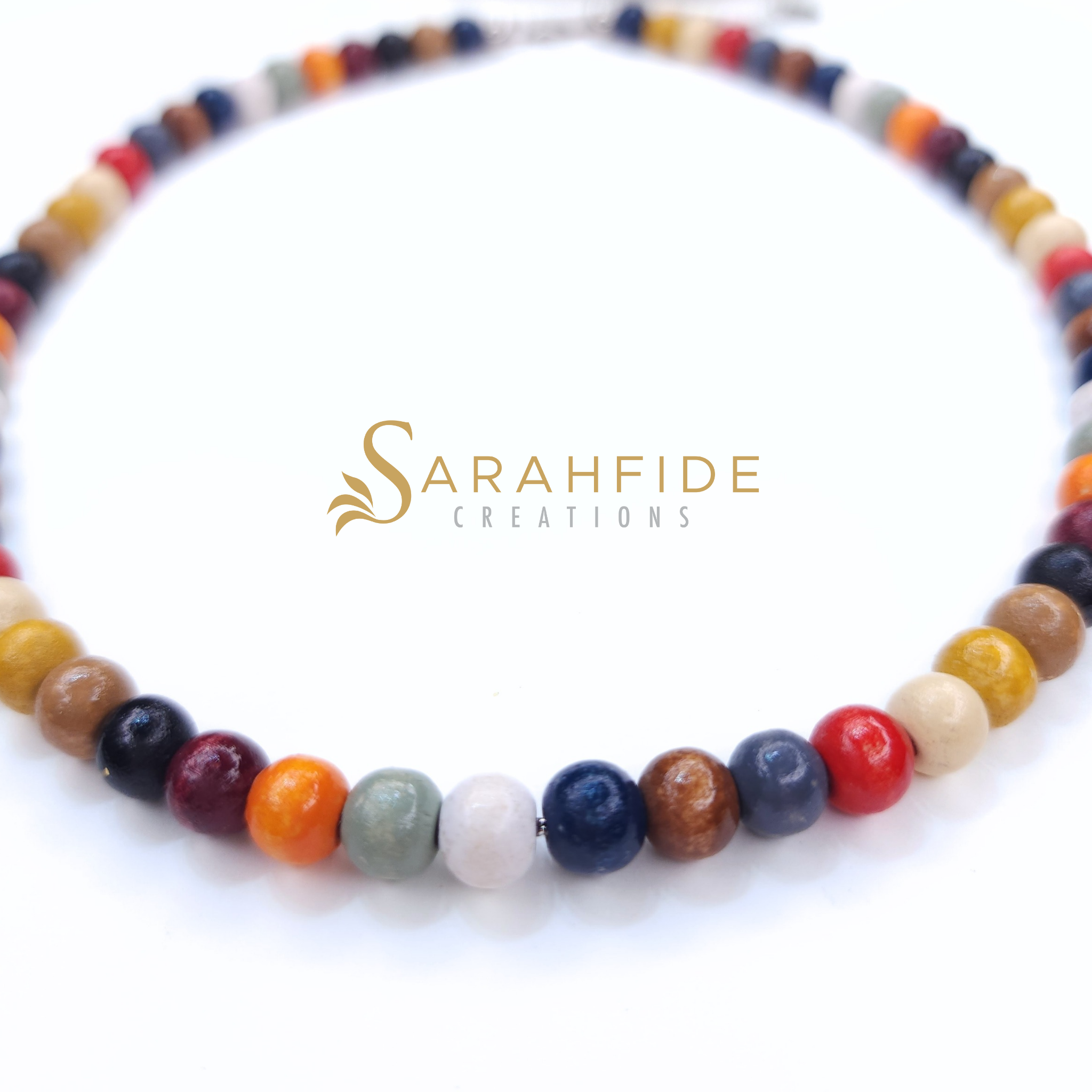 Red, burgundy and orange beaded necklace laid flat