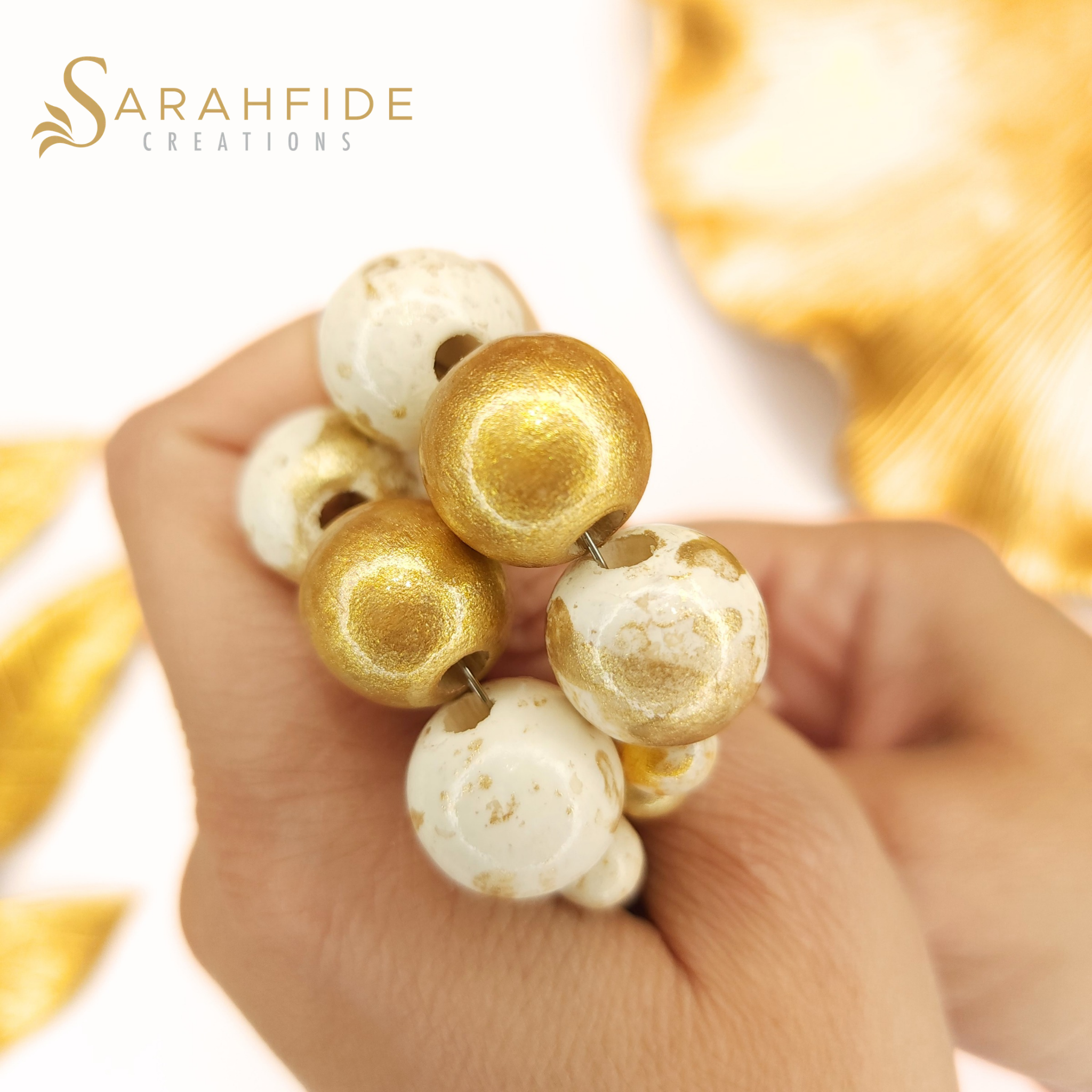 Close-up of Gold Lux beads, warm white with gold marbling and solid gold beads