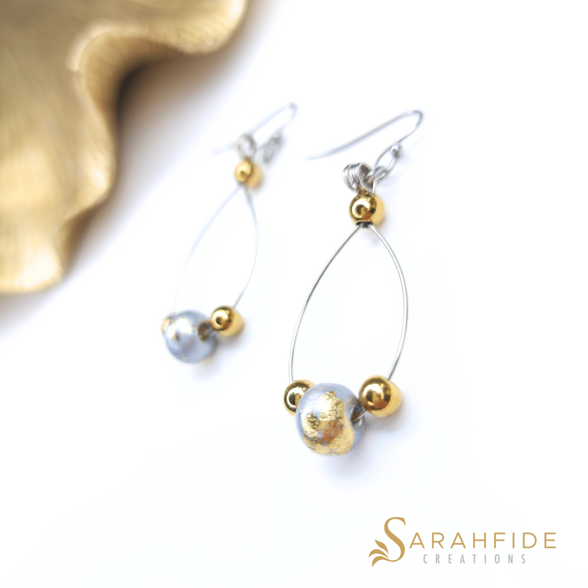 Silver sparkly drop earrings laid flat